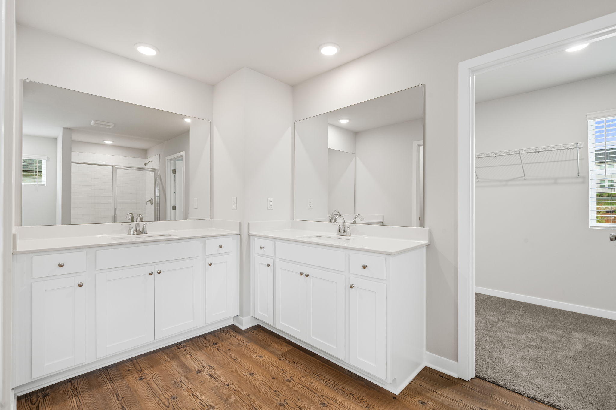 A bathroom with white cabinets.