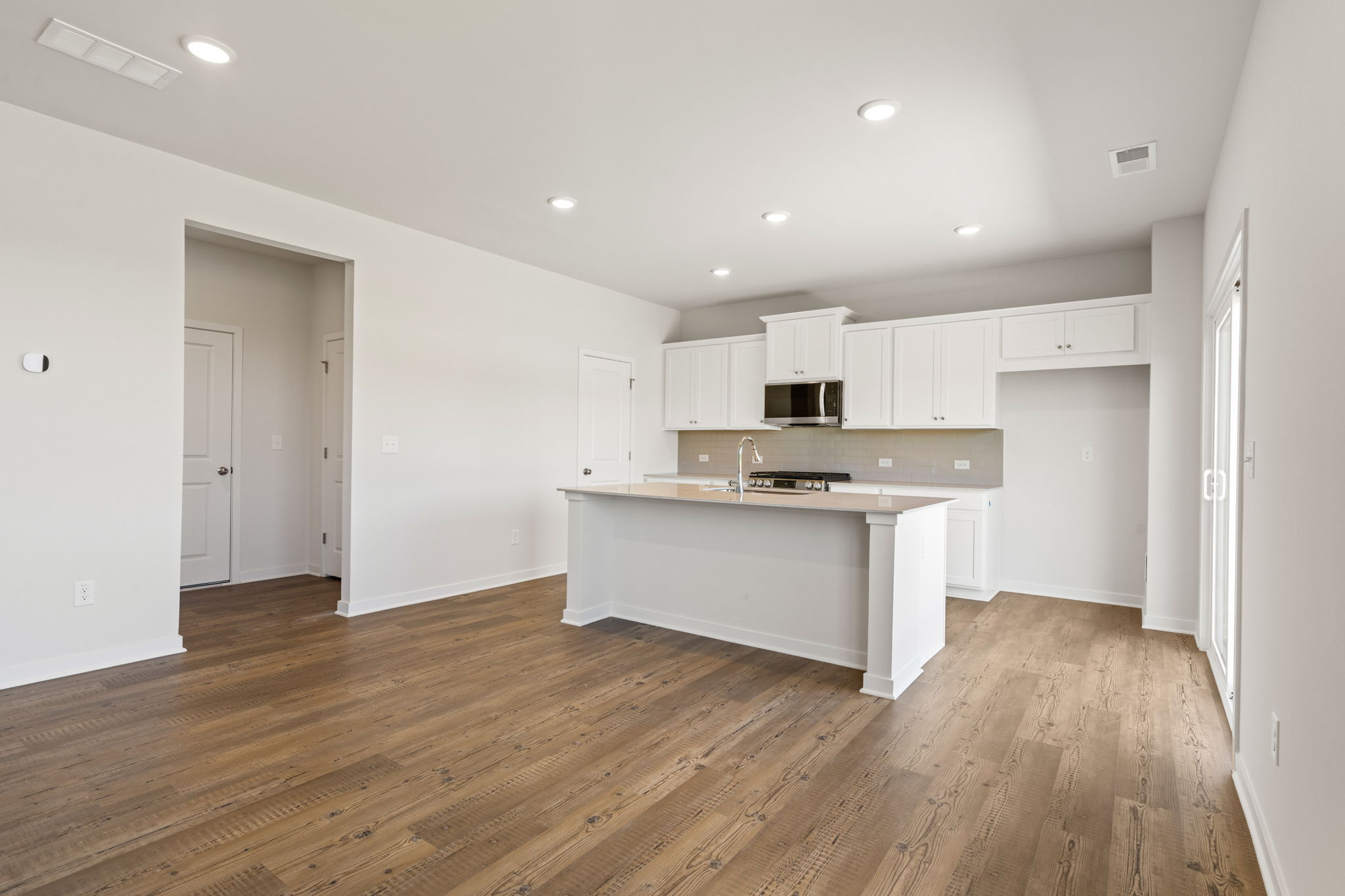 A kitchen with white cabinets.