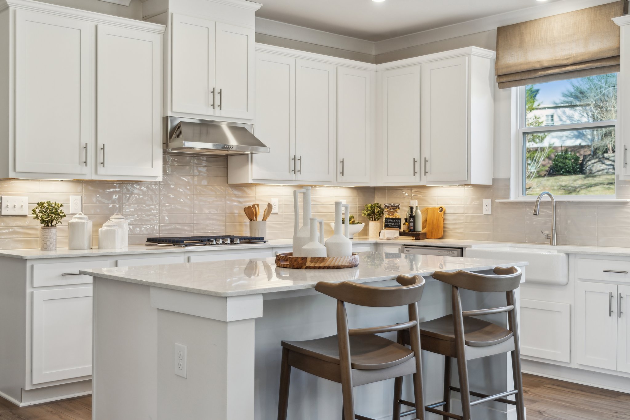A kitchen with white cabinets.