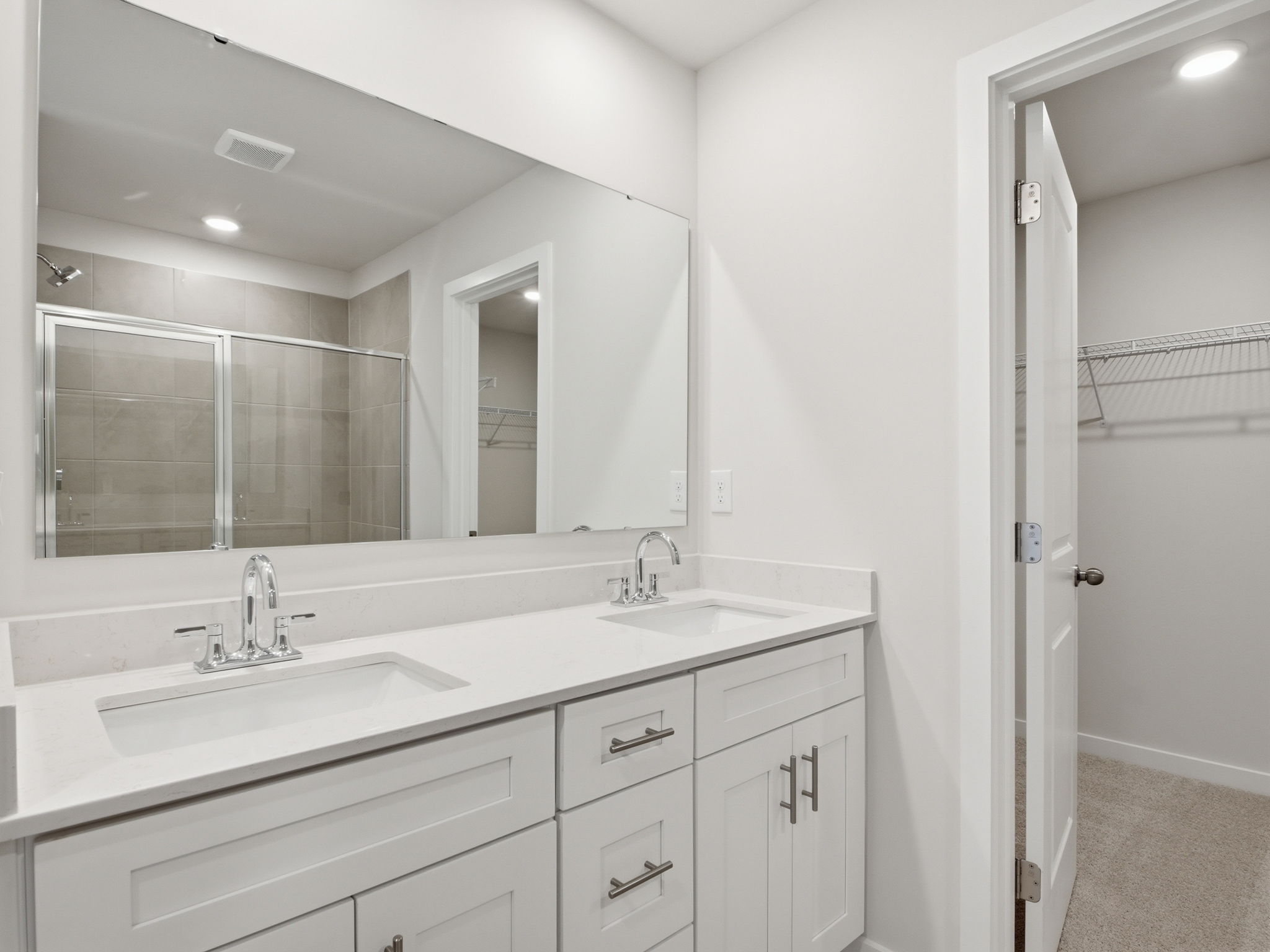 A bathroom with a large mirror.