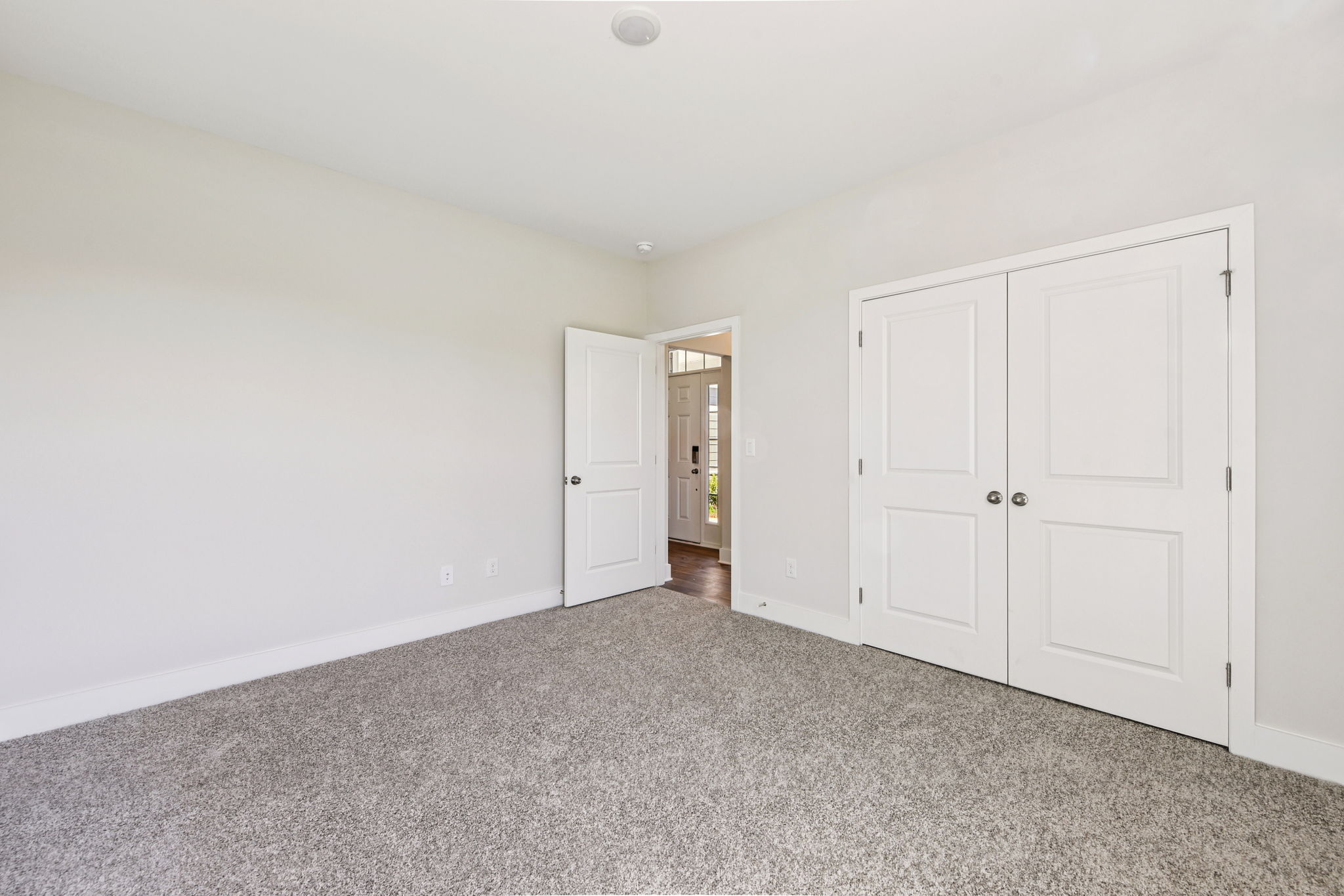 A hallway with white doors.