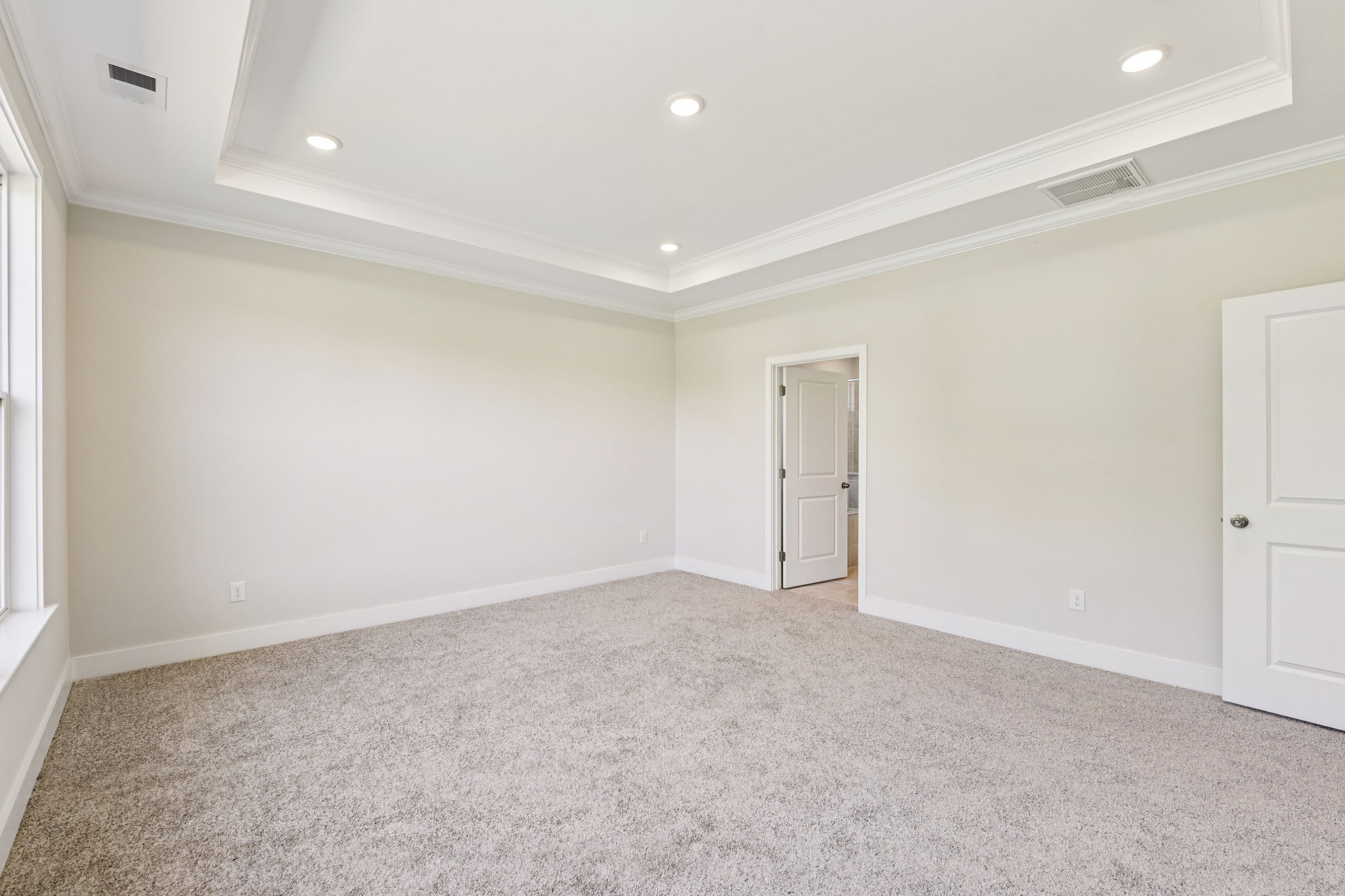 A room with white walls and a carpeted floor.