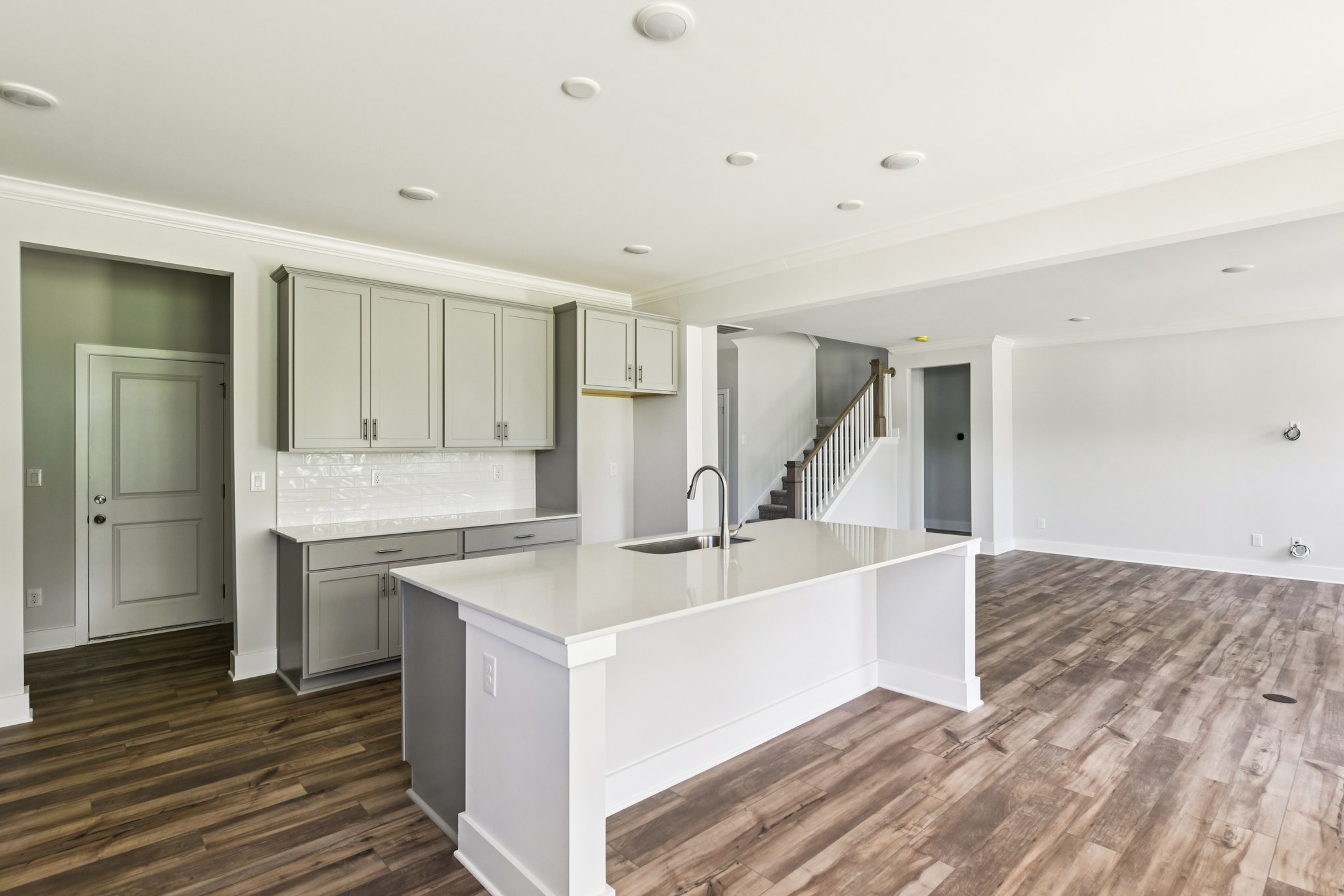 A kitchen with white cabinets.