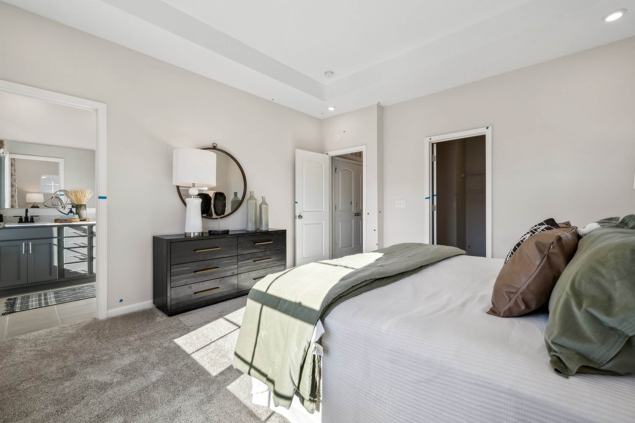 A bedroom with a bed and a dresser.