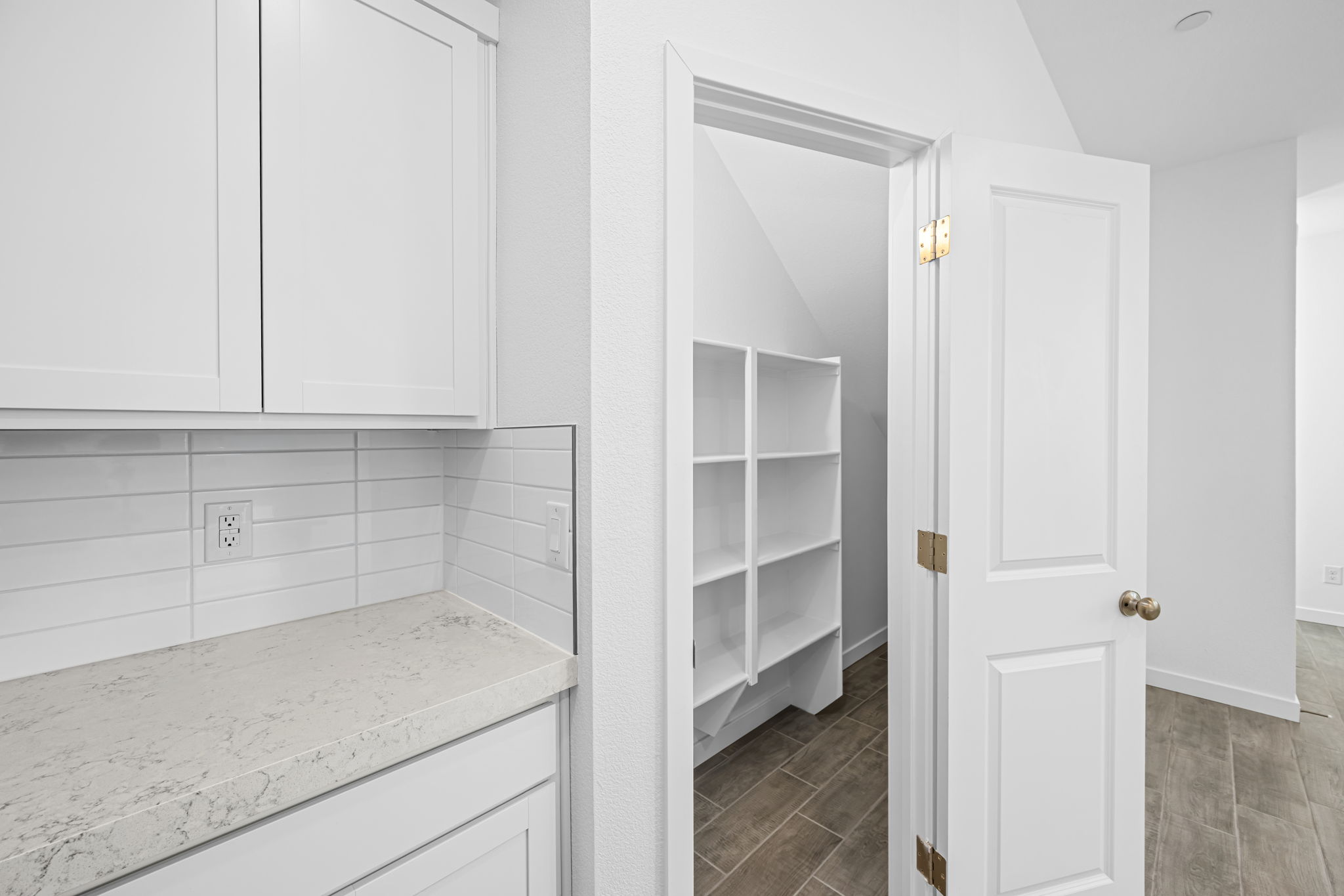A white kitchen with white cabinets.