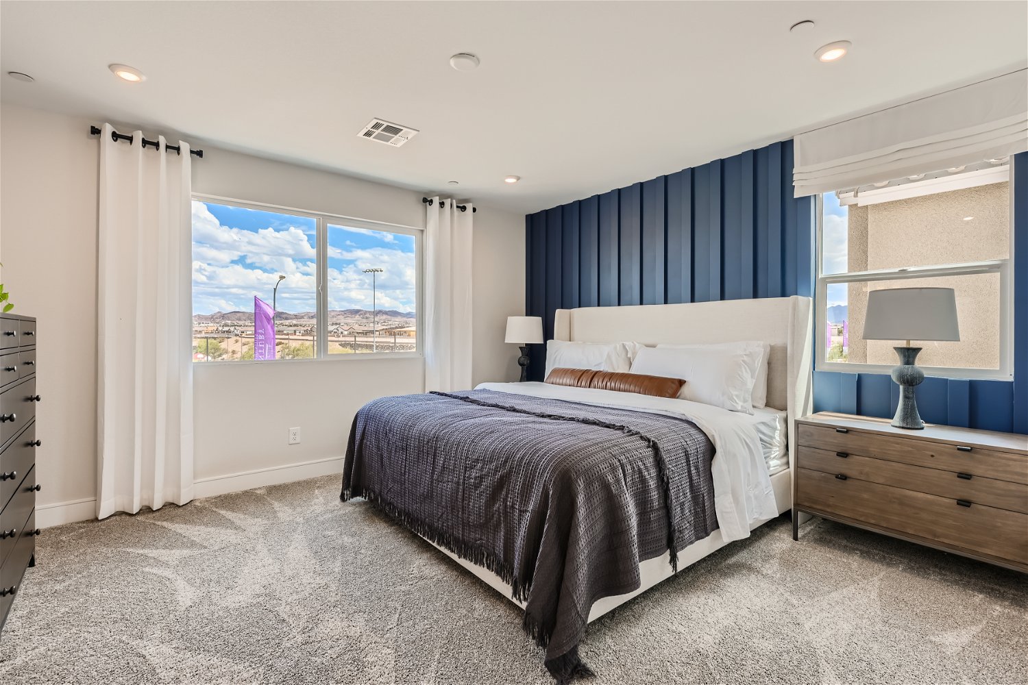 A bedroom with a large window.