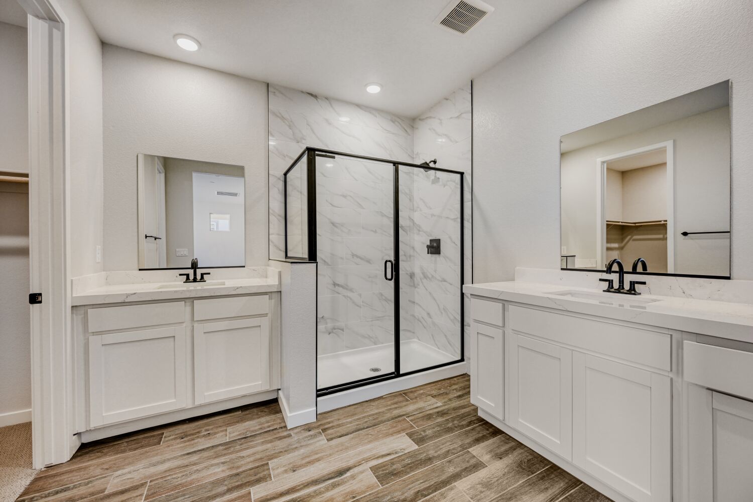 A bathroom with white cabinets.