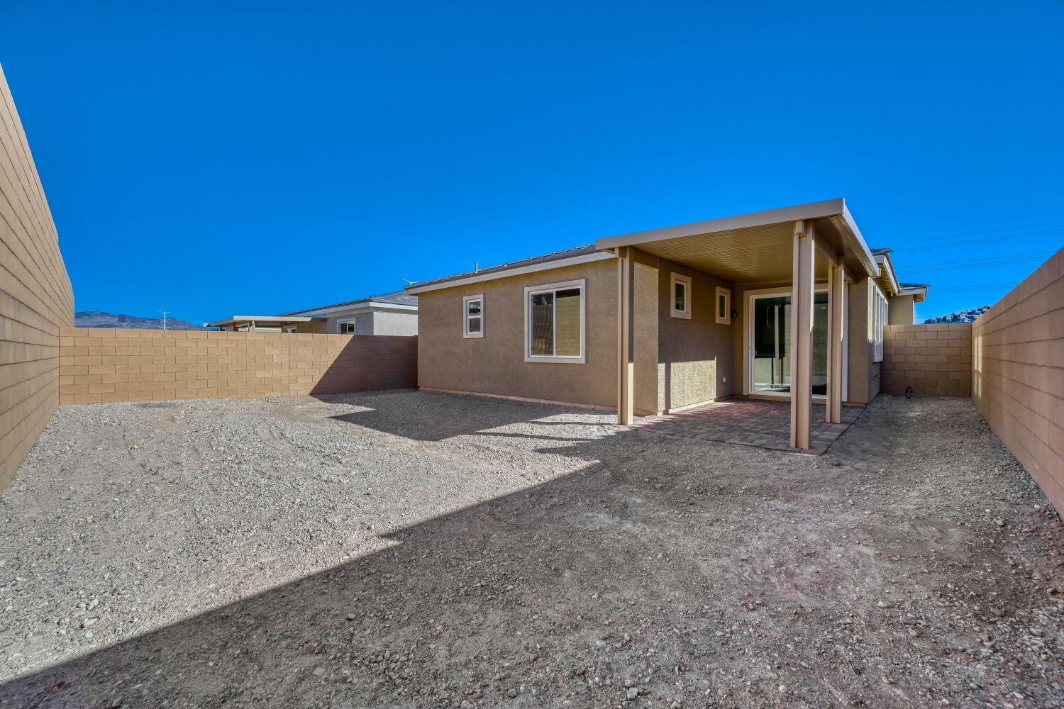 A building with a gravel driveway.