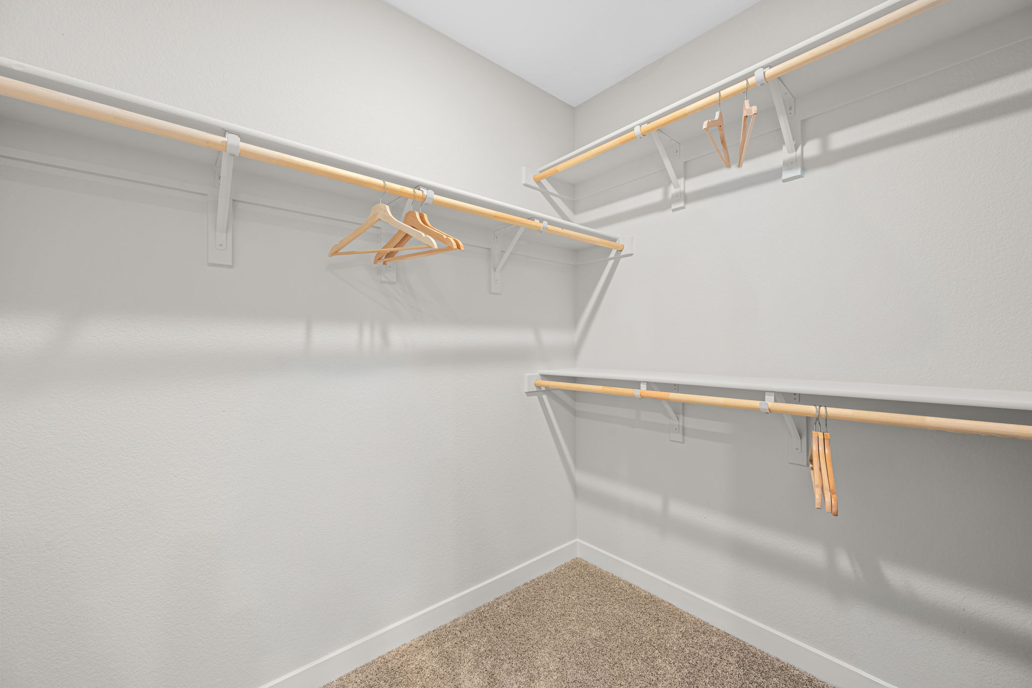 A white wall with a wooden railing.