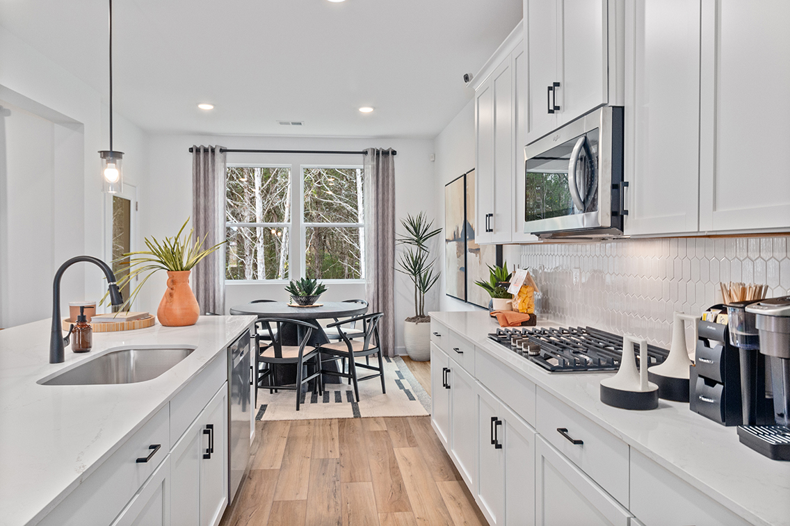 A kitchen with white cabinets.