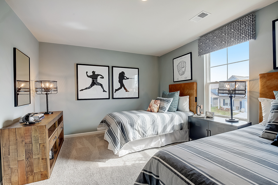 A bedroom with a bed and a window.