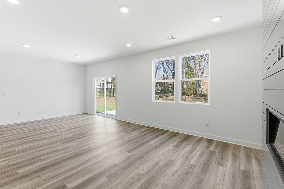 A room with a wood floor and windows.