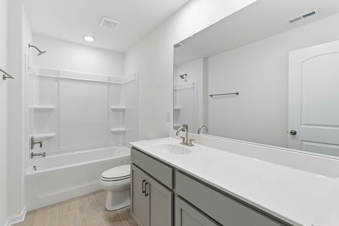 A bathroom with a tub toilet and sink.