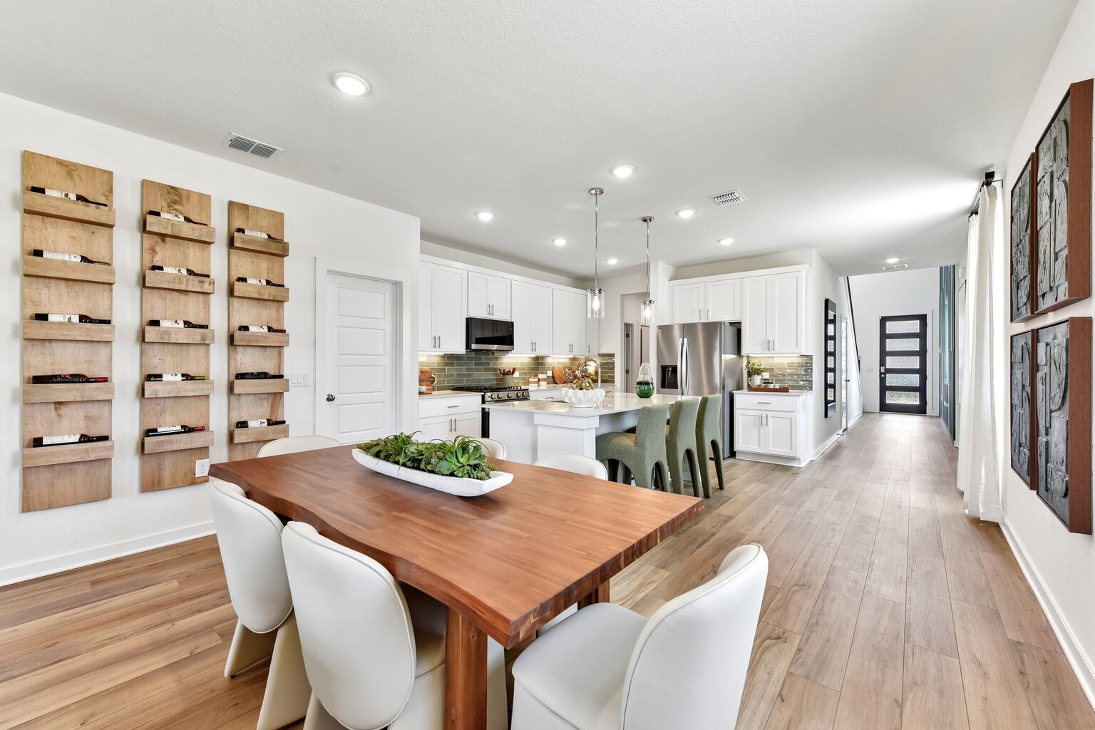 A kitchen with a dining table and chairs.