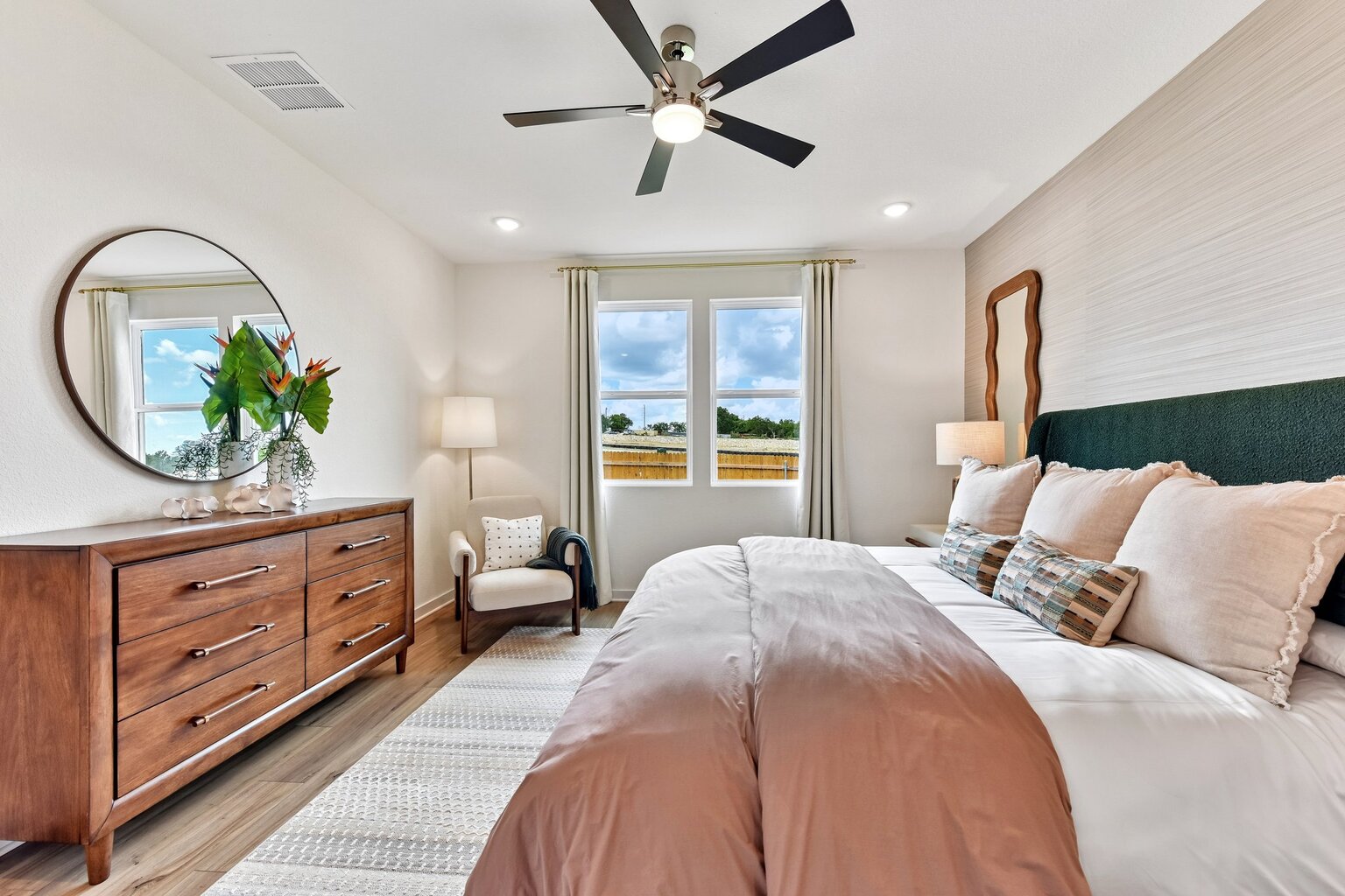 A bedroom with a large bed and a large window.