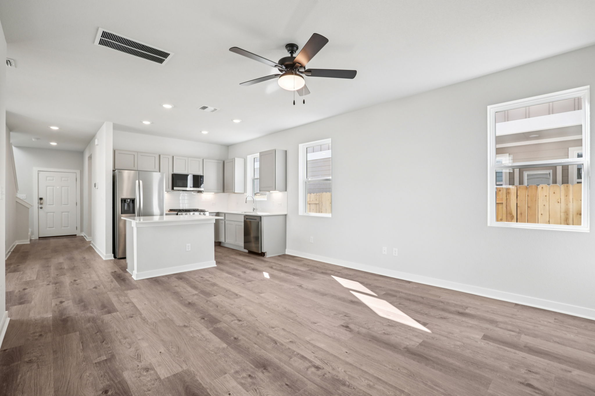 A kitchen with white cabinets.