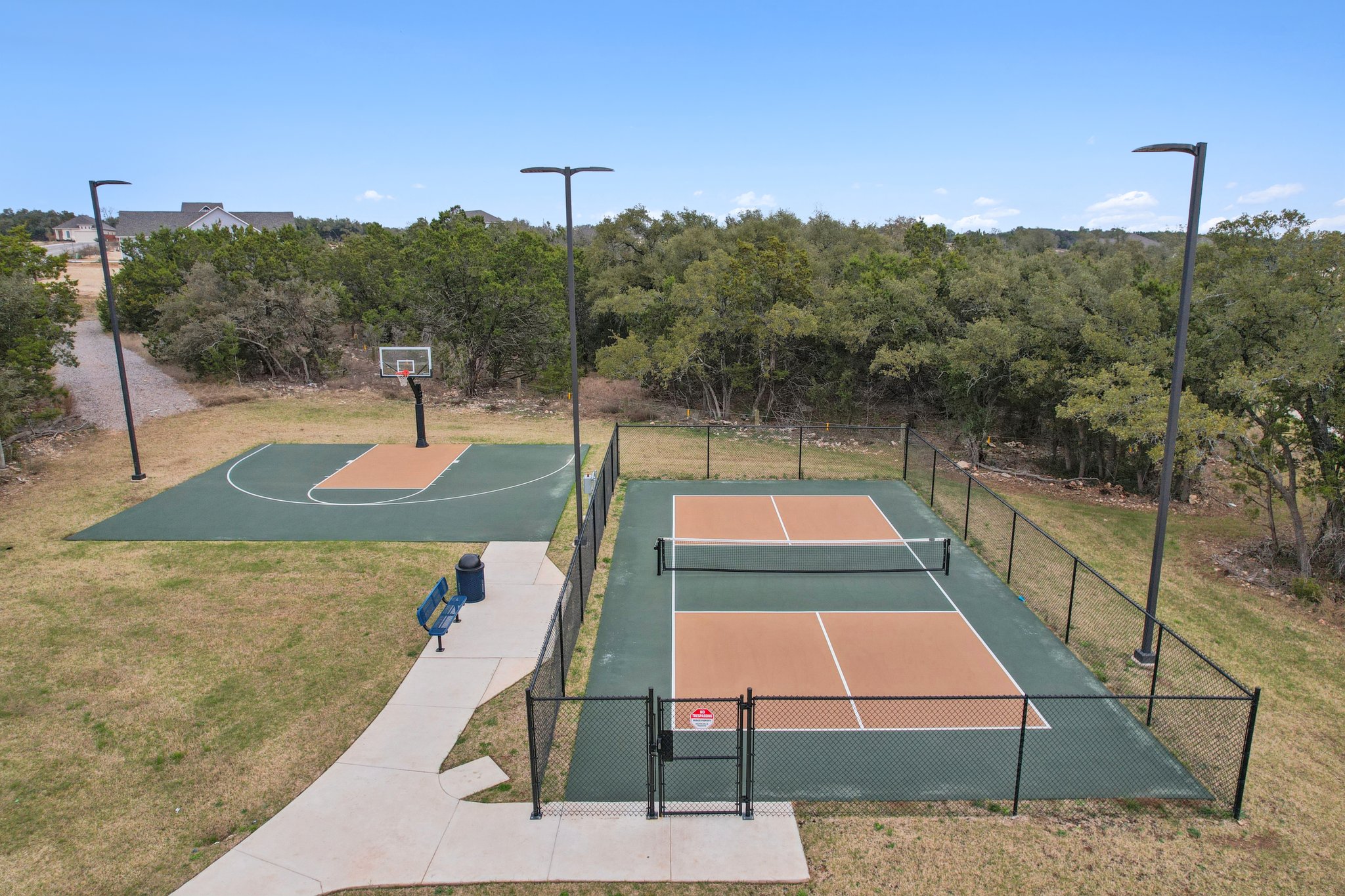 A tennis court with a fence.