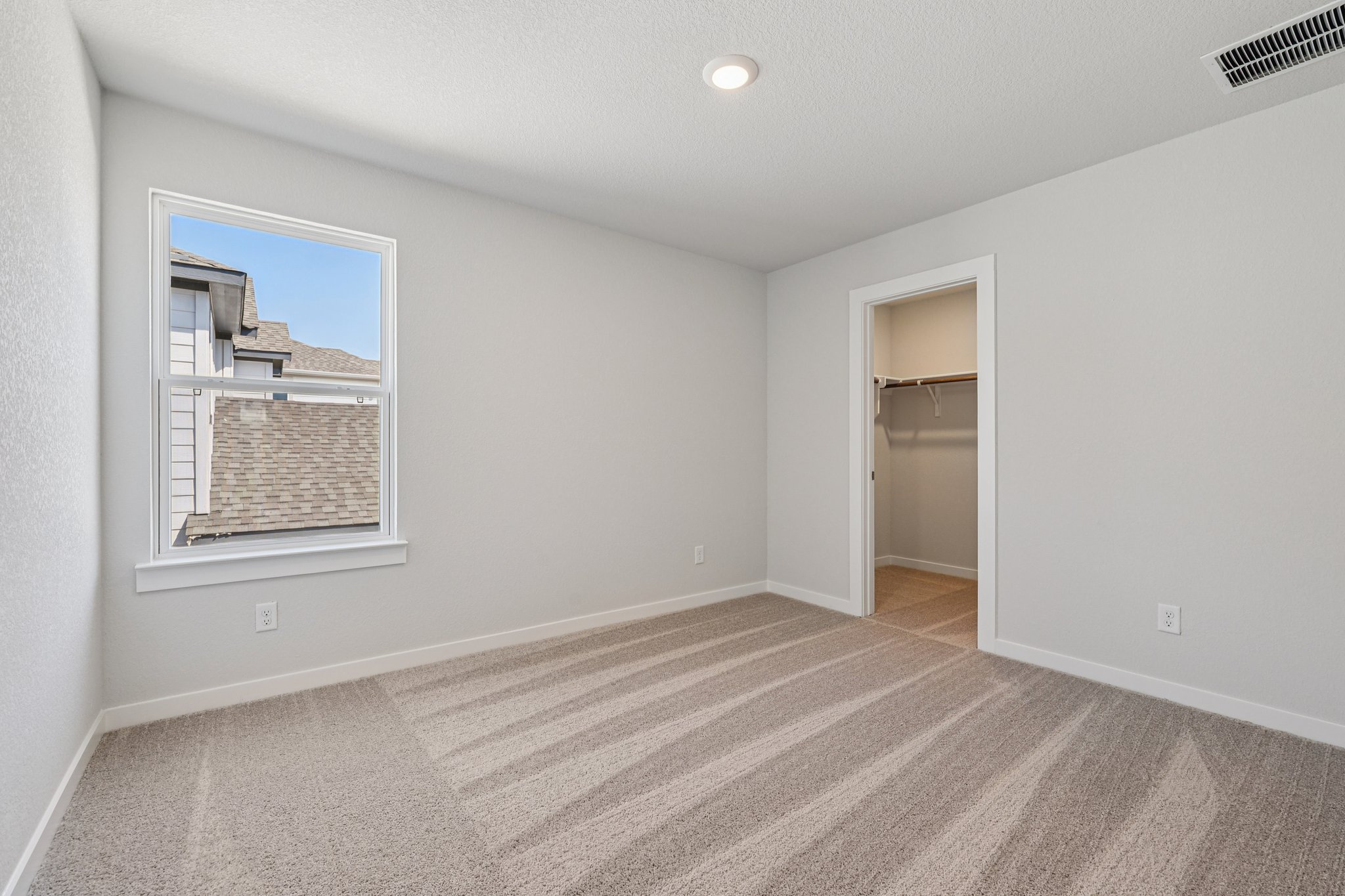 A room with a window and a door.