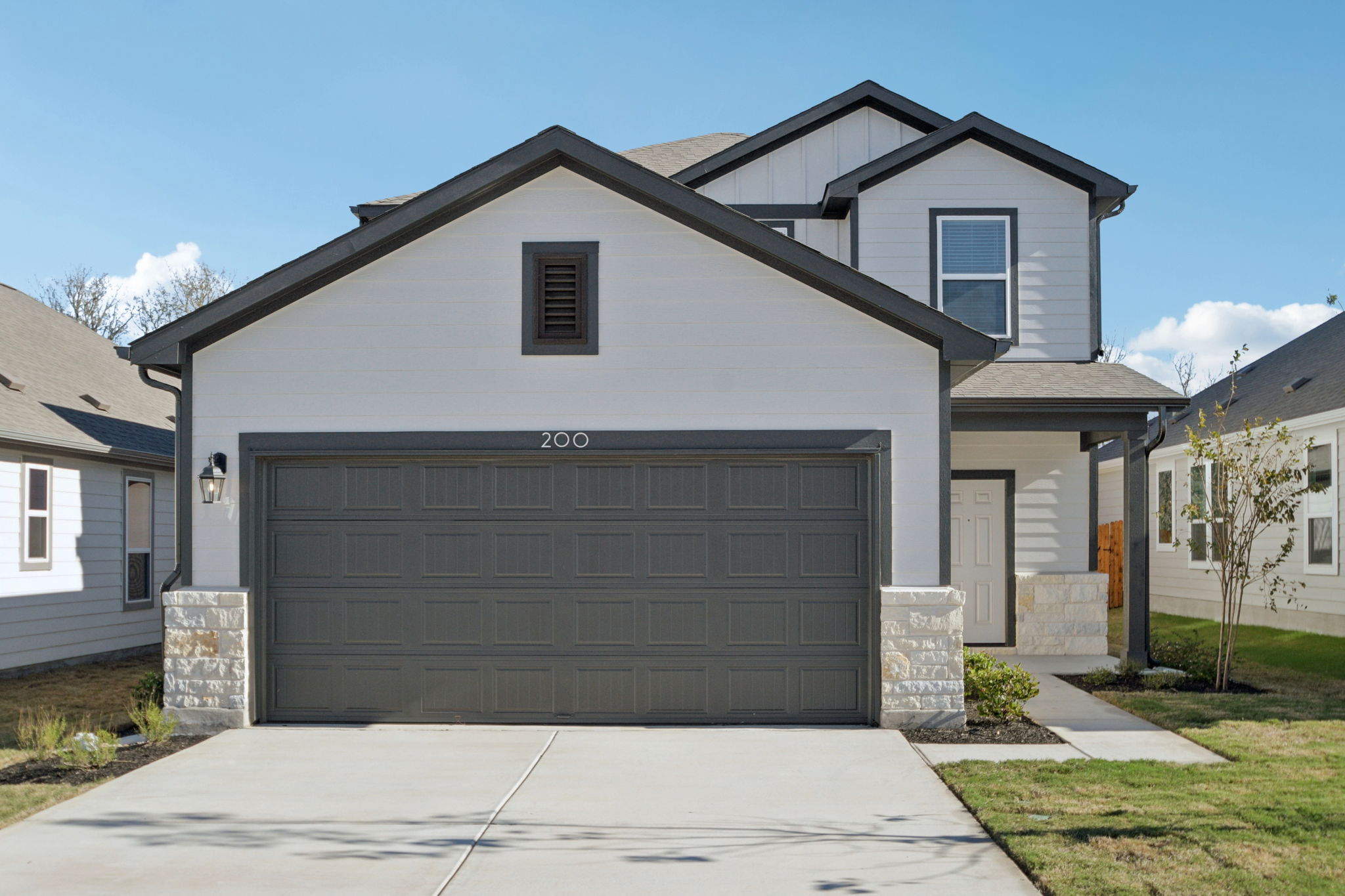 A grey house with a garage.