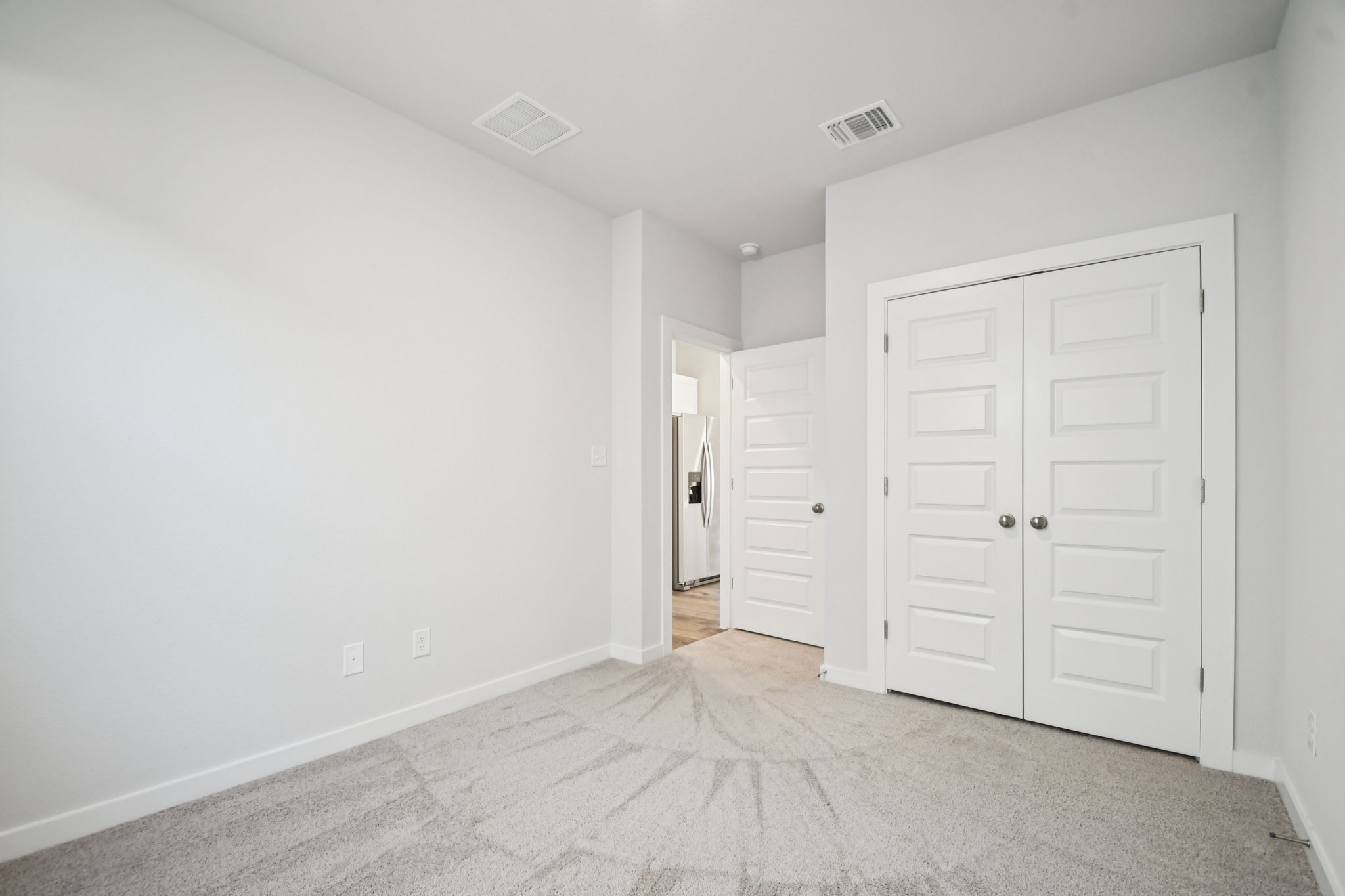 A hallway with white doors.