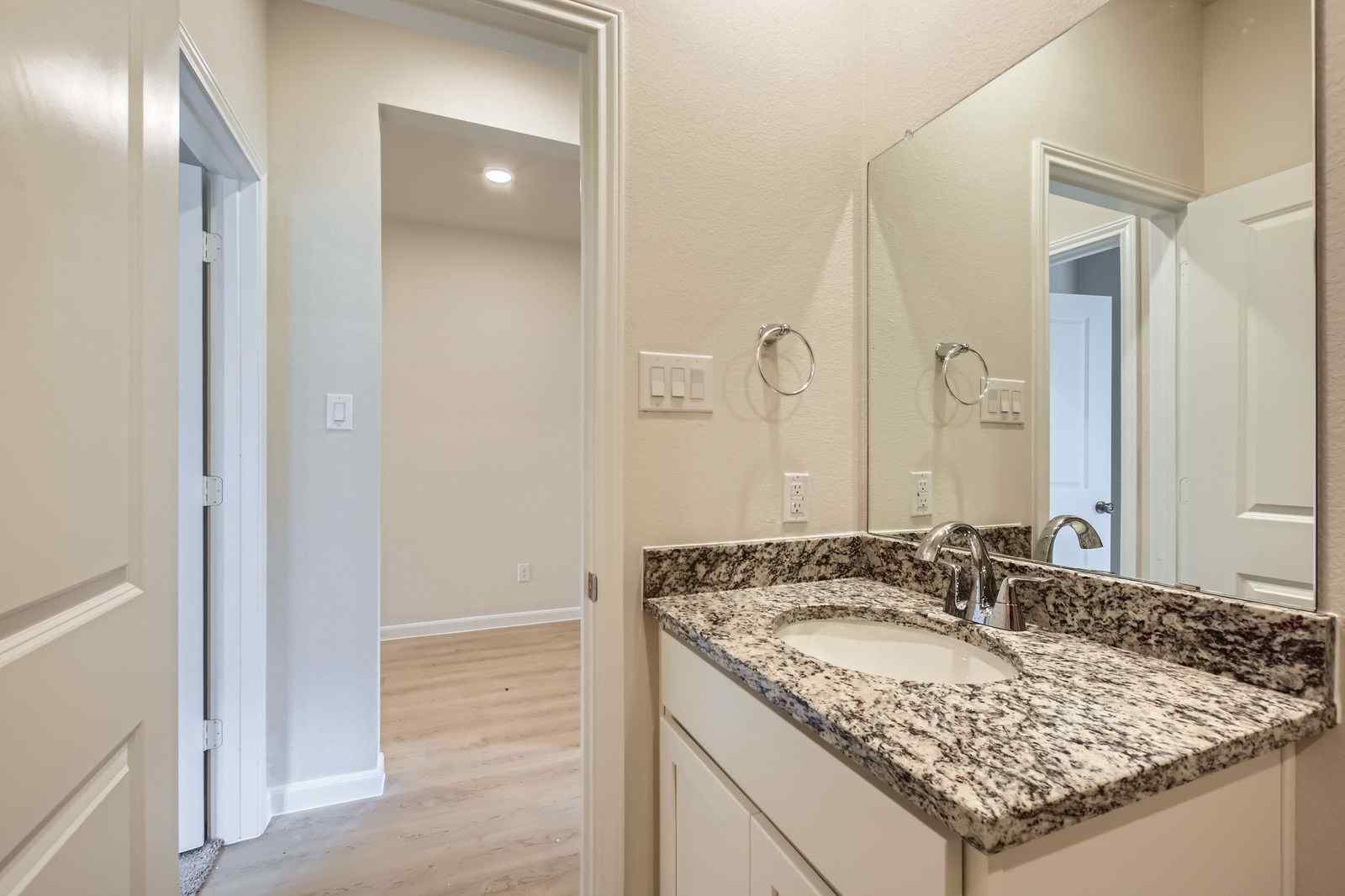 A bathroom with a marble countertop.