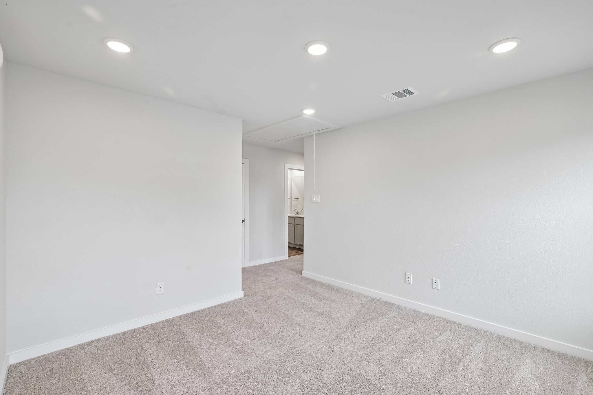 A long hallway with white walls.