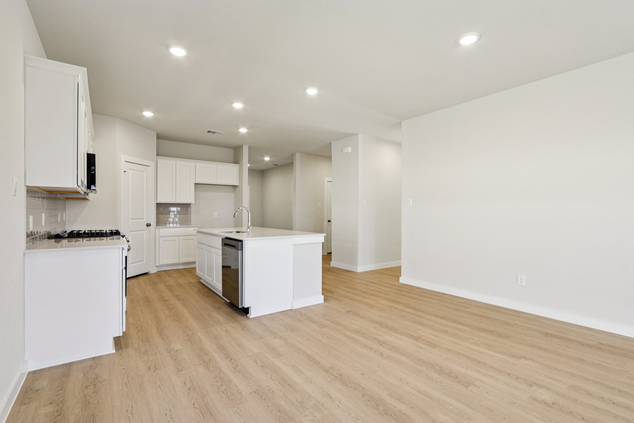 A kitchen with white cabinets.
