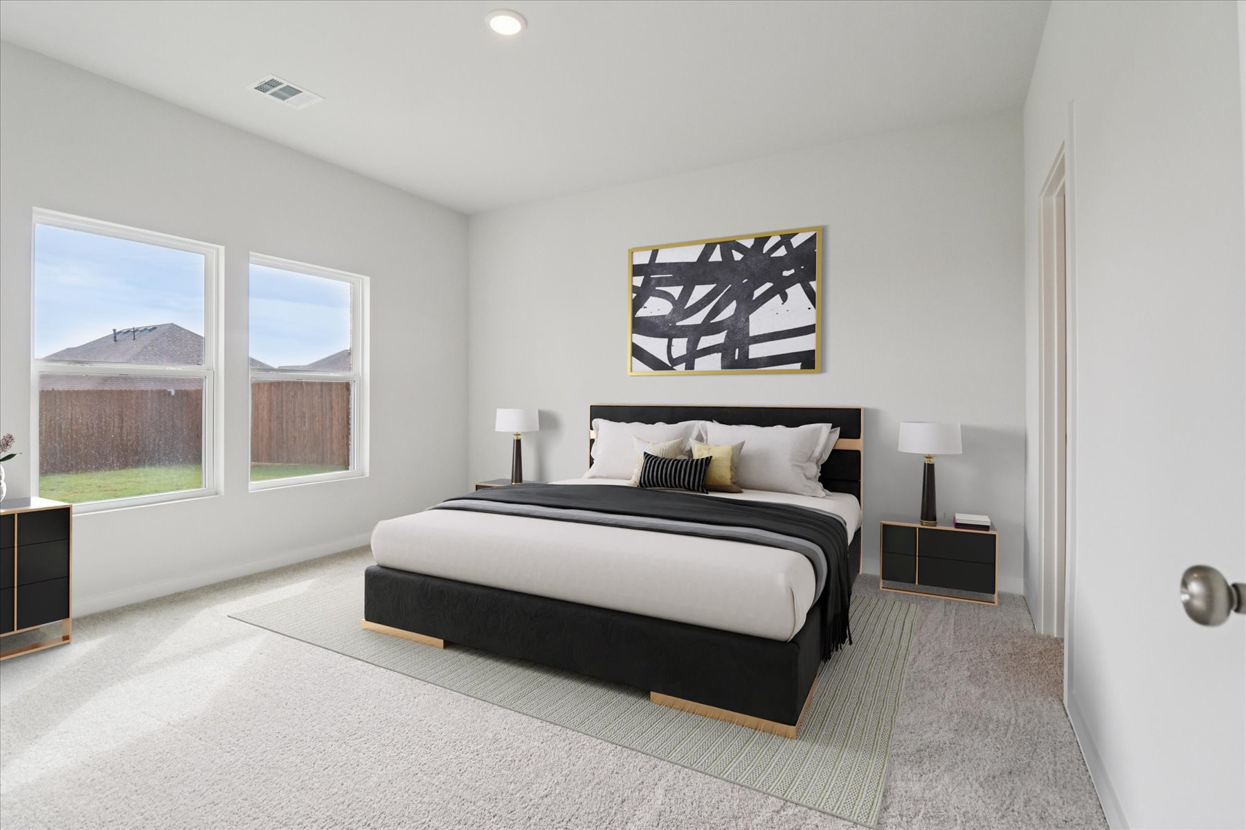A bedroom with a large window.