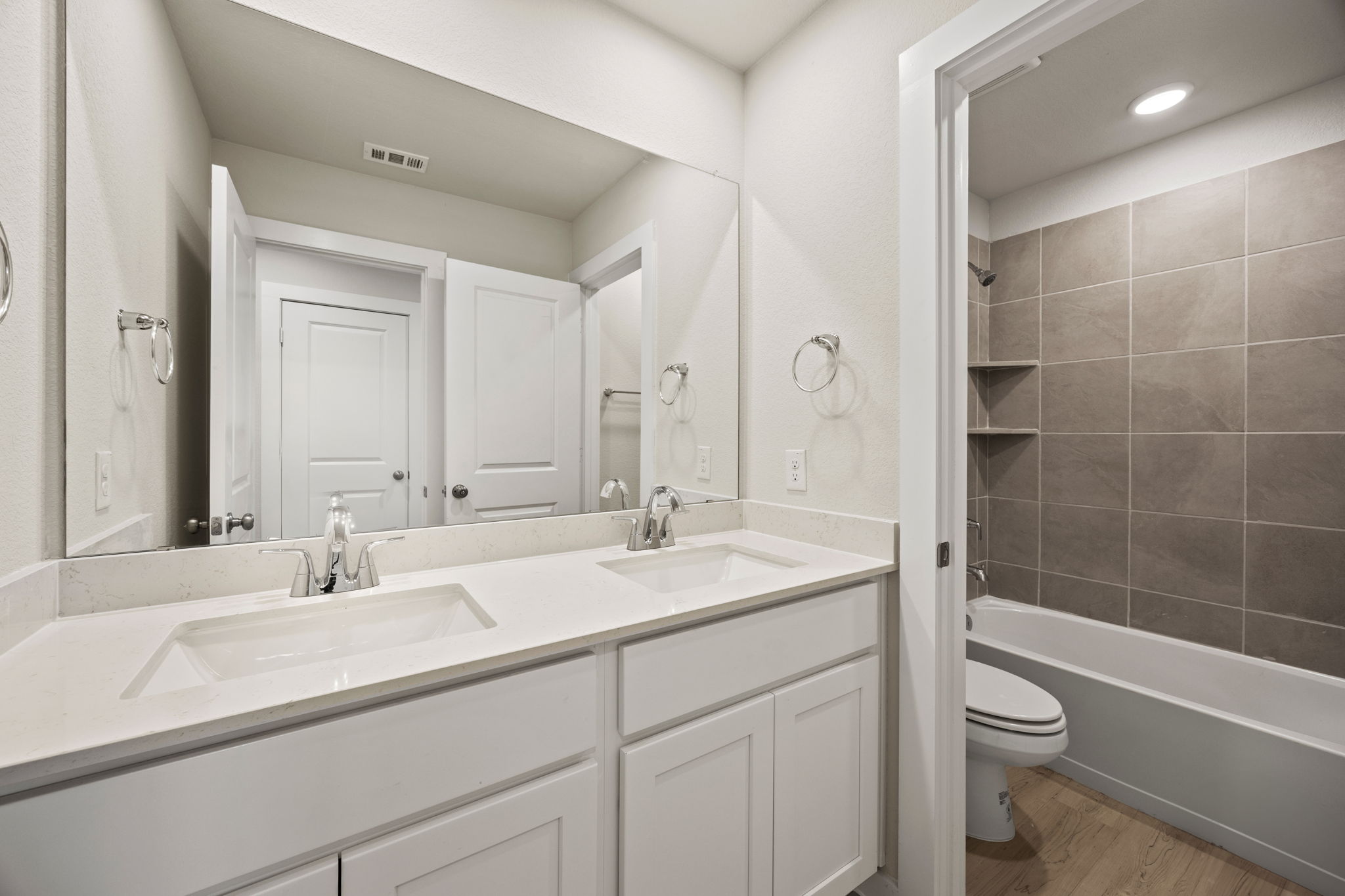 A bathroom with a tub sink and toilet.