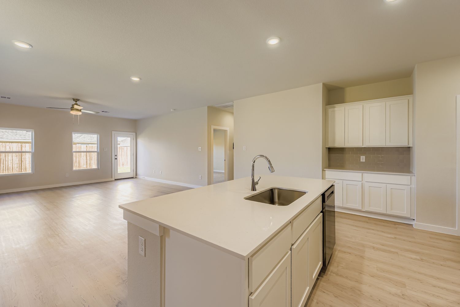 A kitchen with white cabinets.