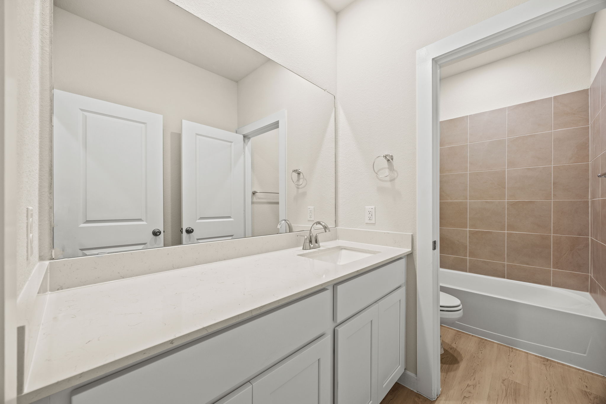 A bathroom with a tub sink and toilet.