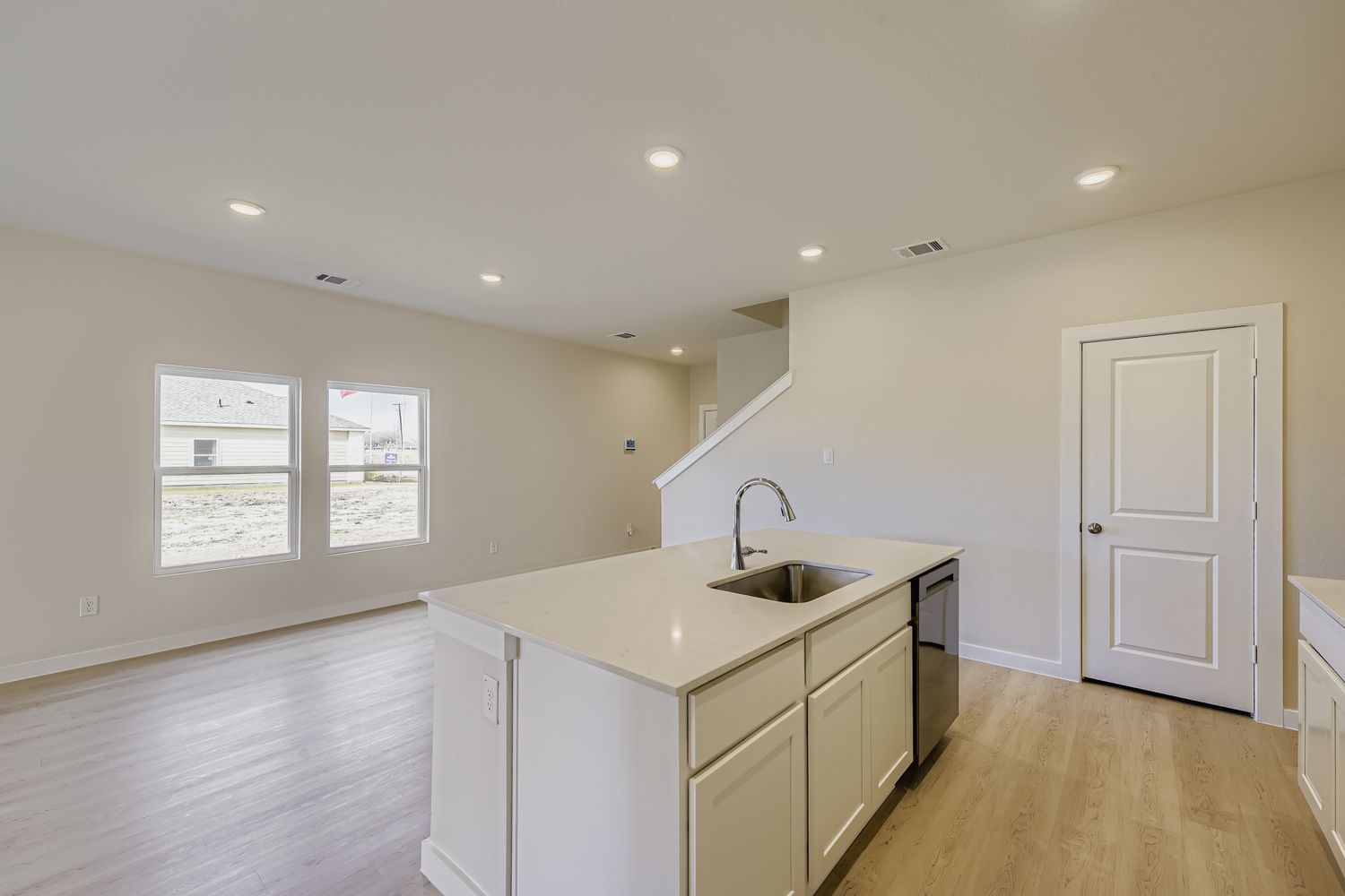 A kitchen with white cabinets.