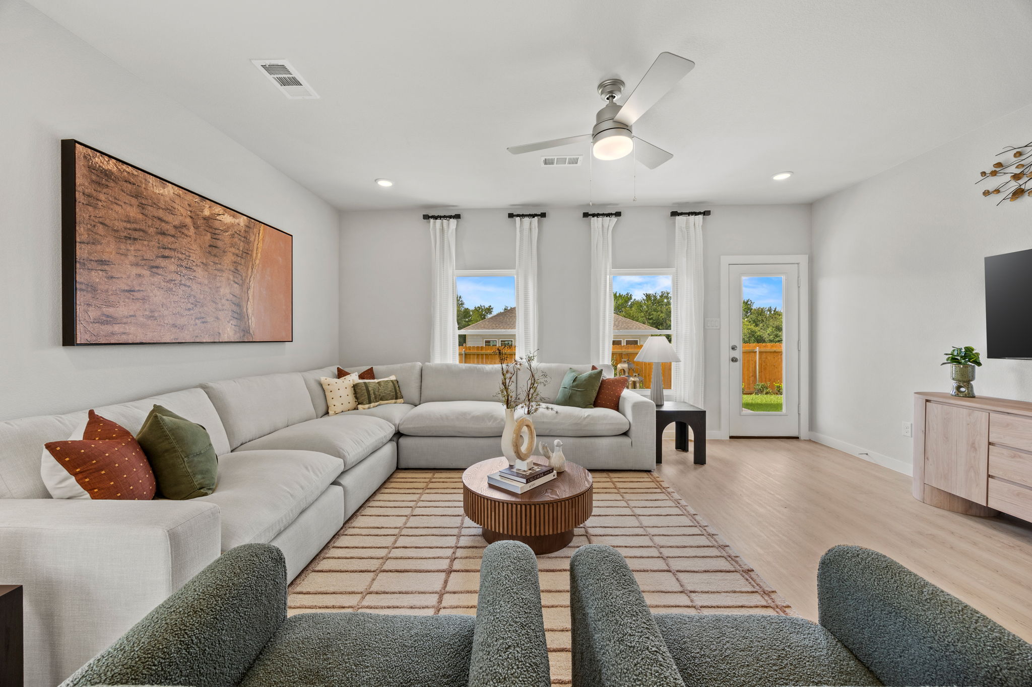 A living room with a large white couch and a large chandelier.