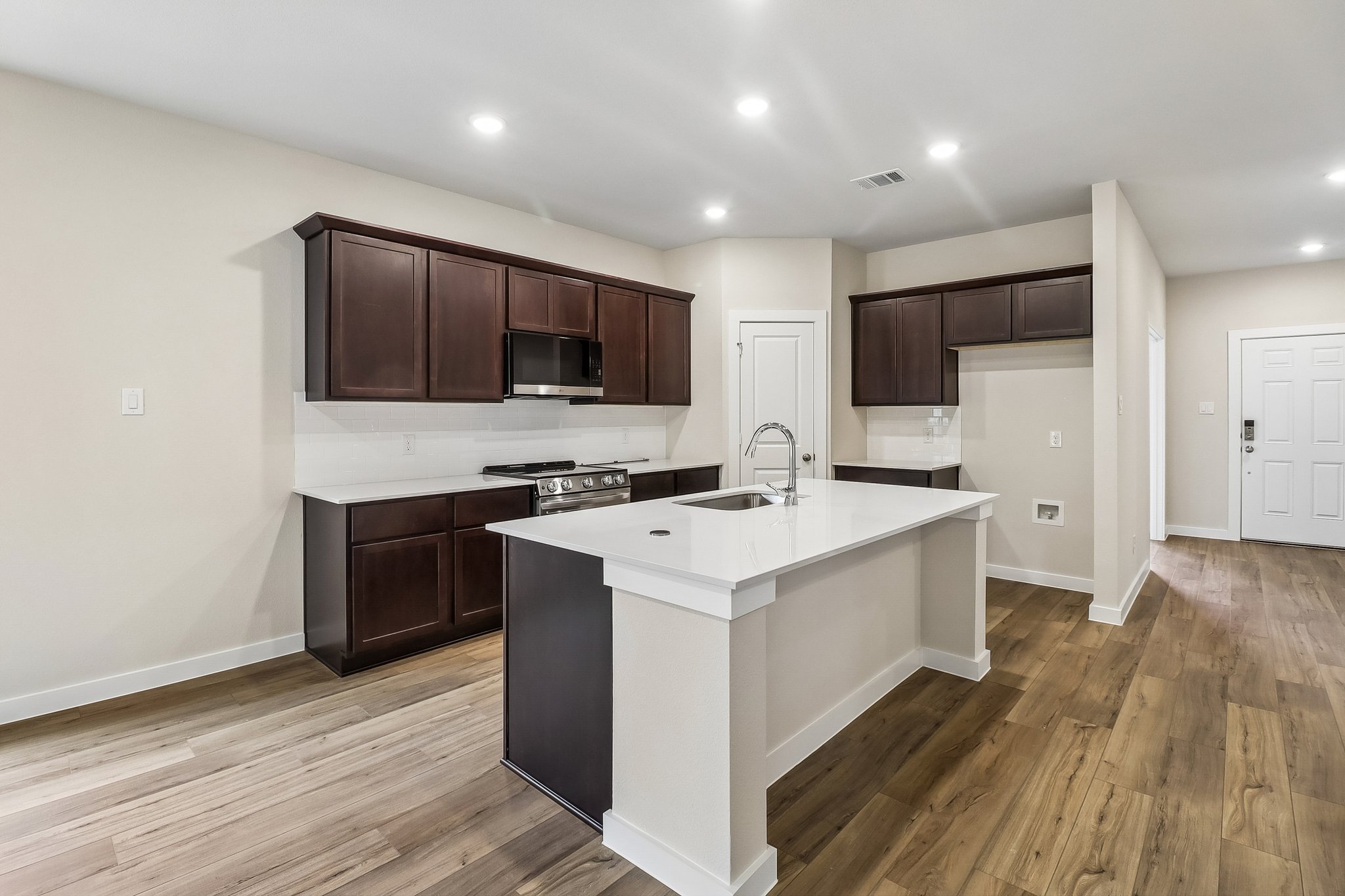 A kitchen with wooden cabinets.