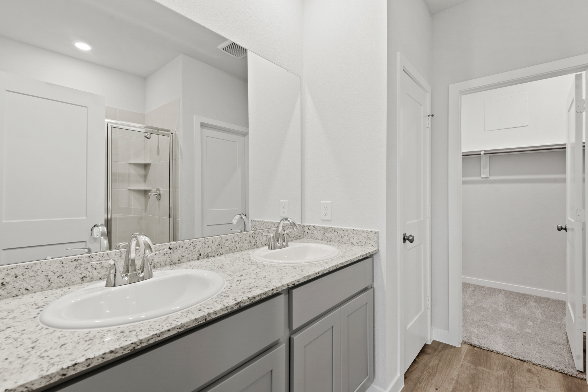 A bathroom with a large mirror.
