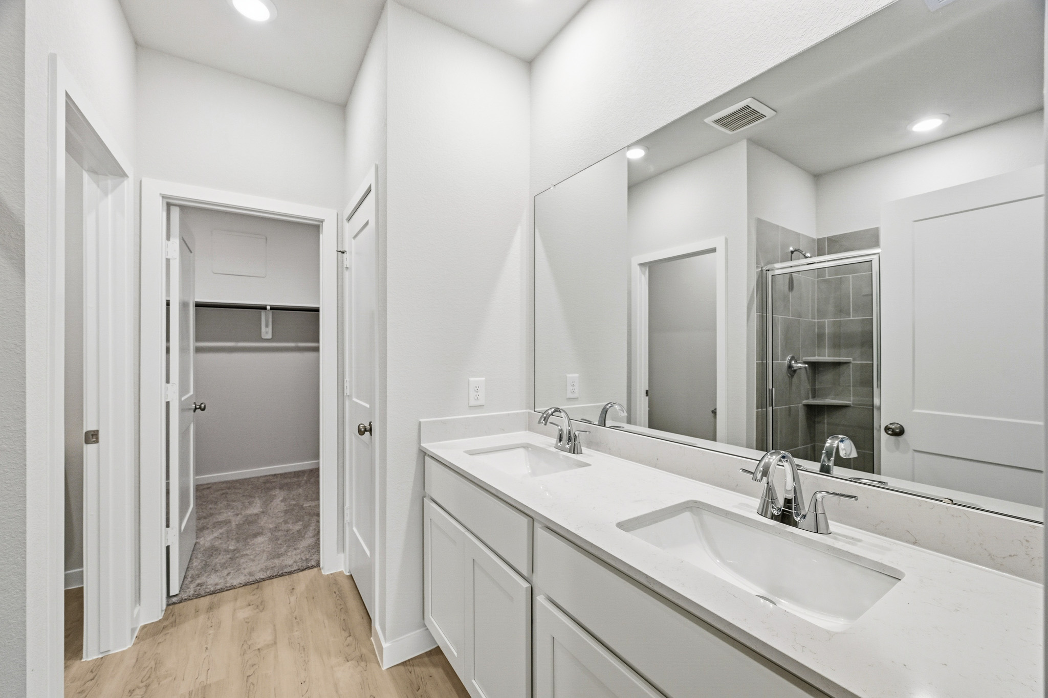 A bathroom with a large mirror.