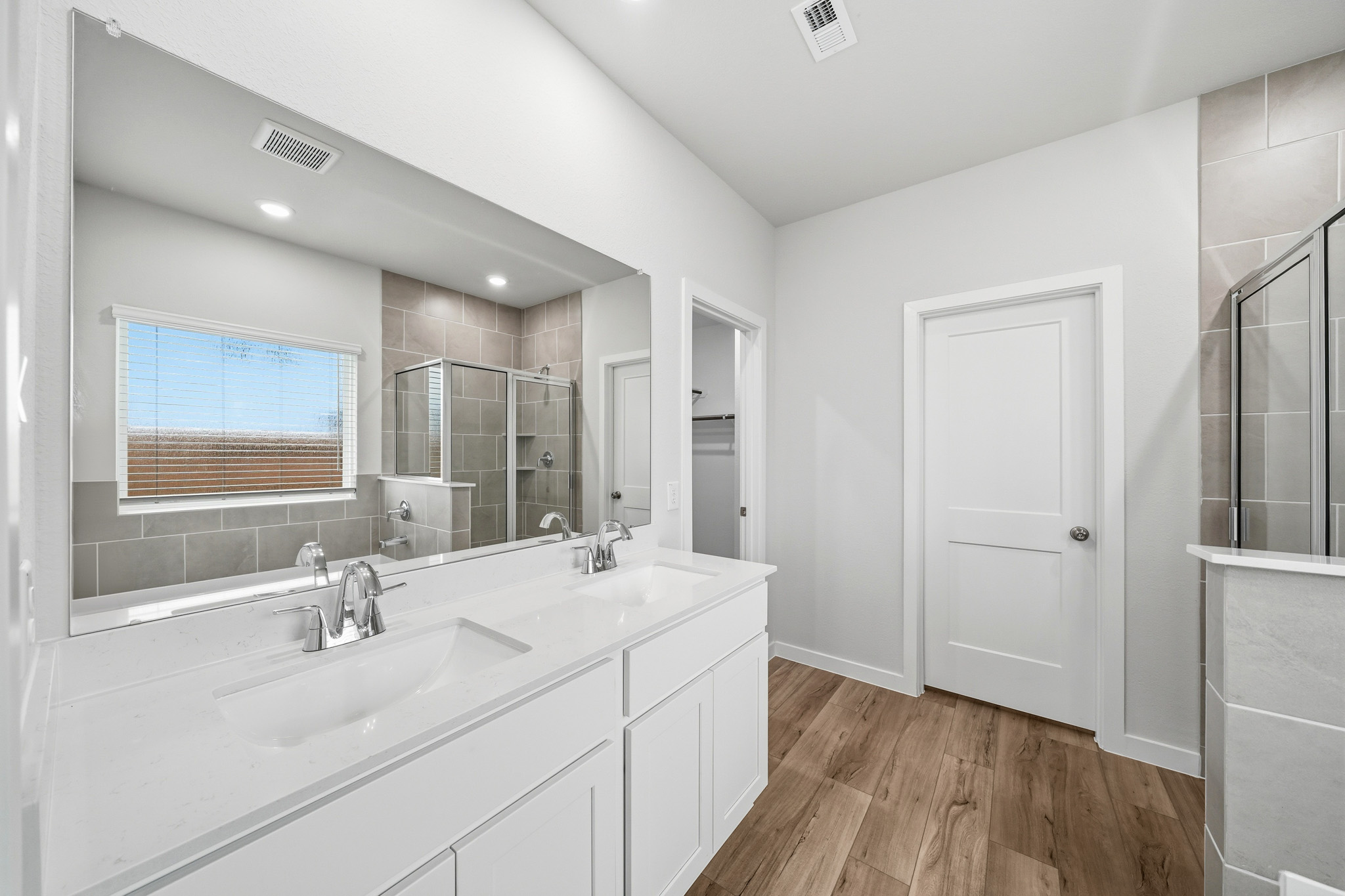 A bathroom with white cabinets.