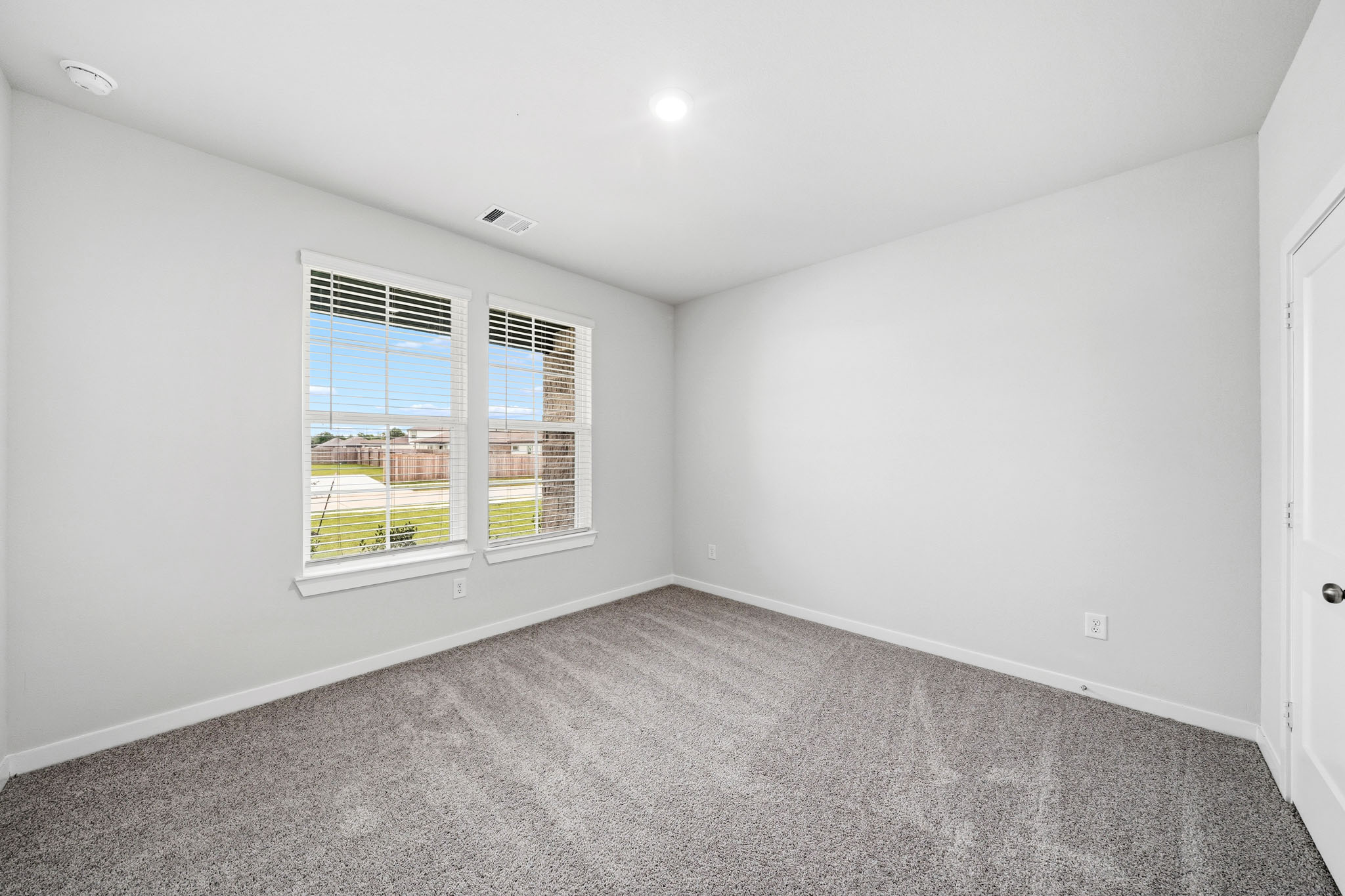 A room with a window and a door.