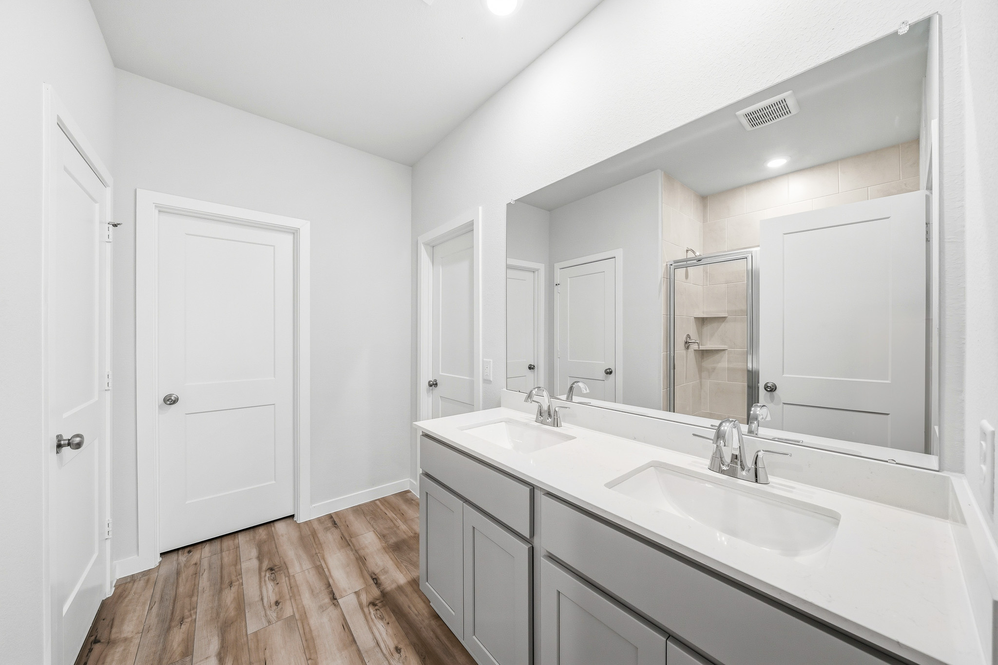 A bathroom with a large mirror.