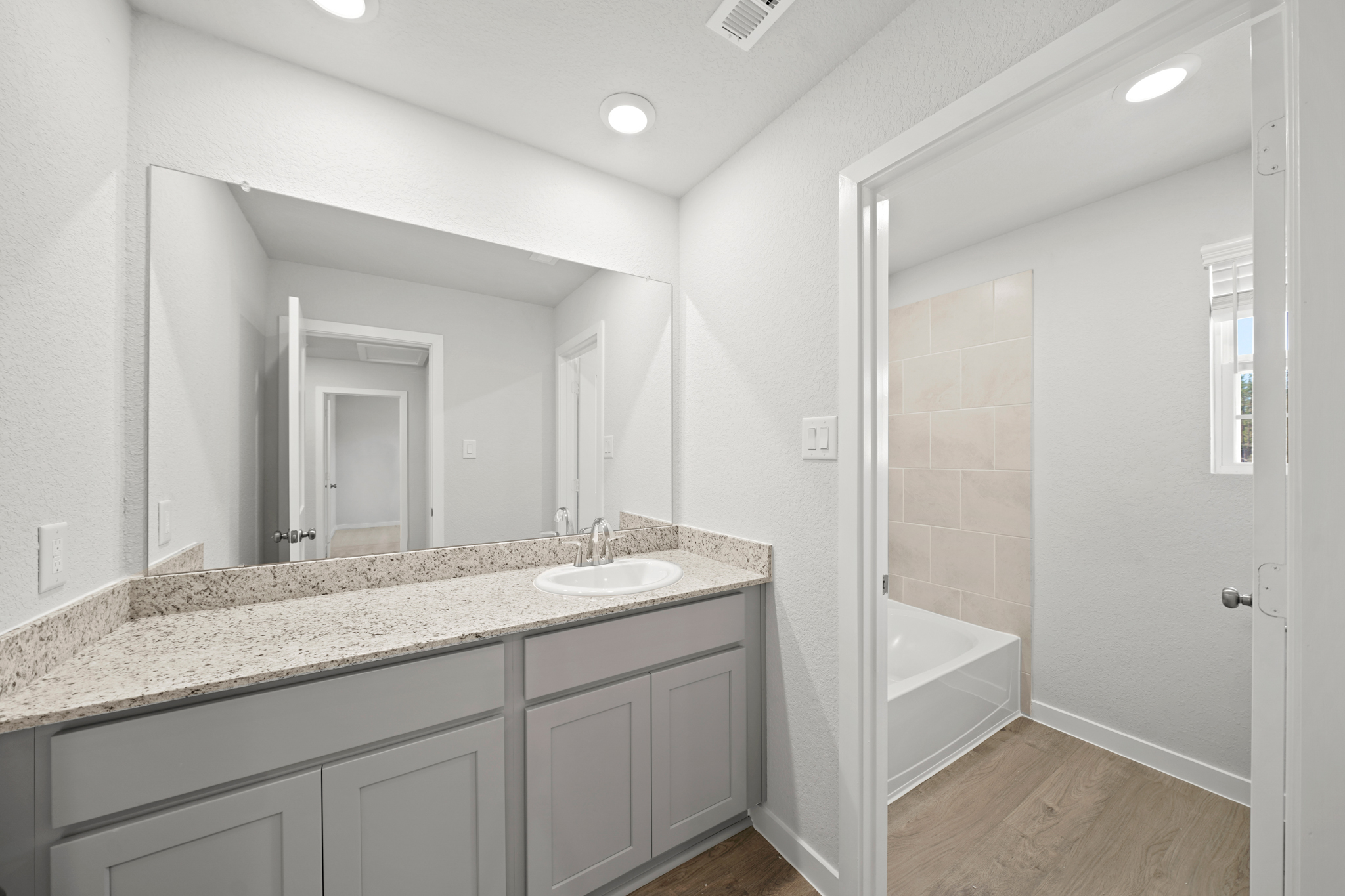A bathroom with a marble countertop.