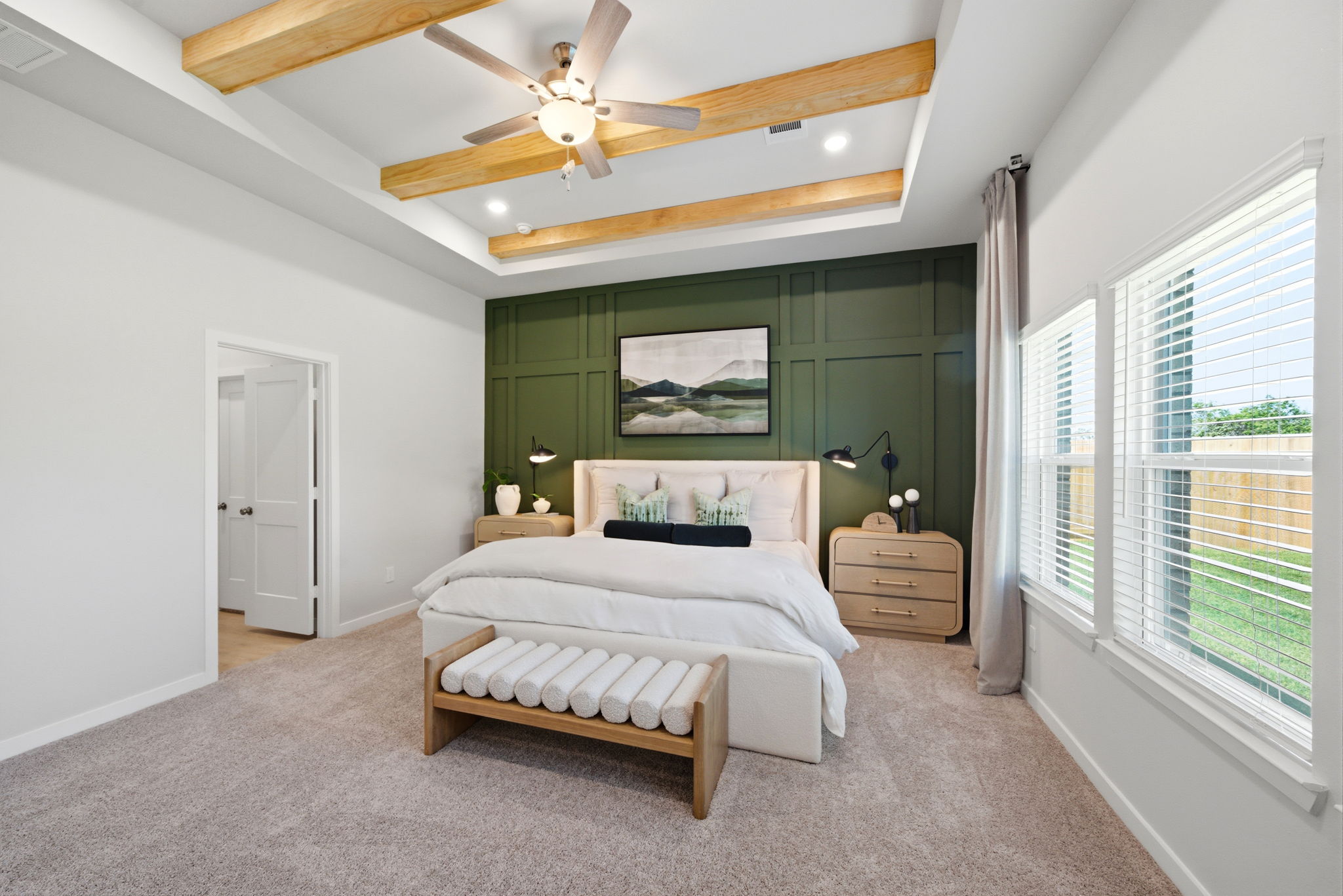 A bedroom with a bed and a fan.