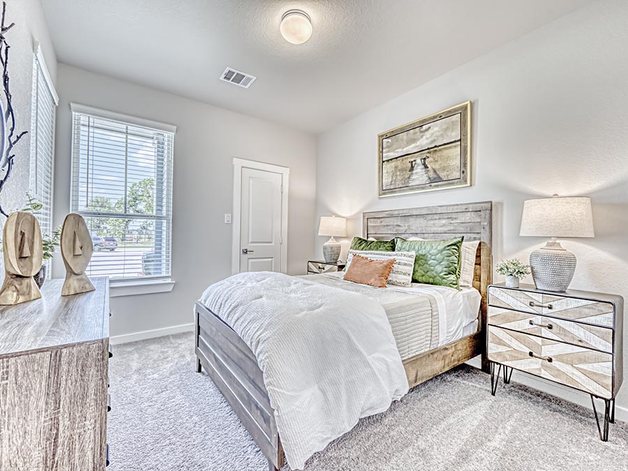 A bedroom with a bed and a table.