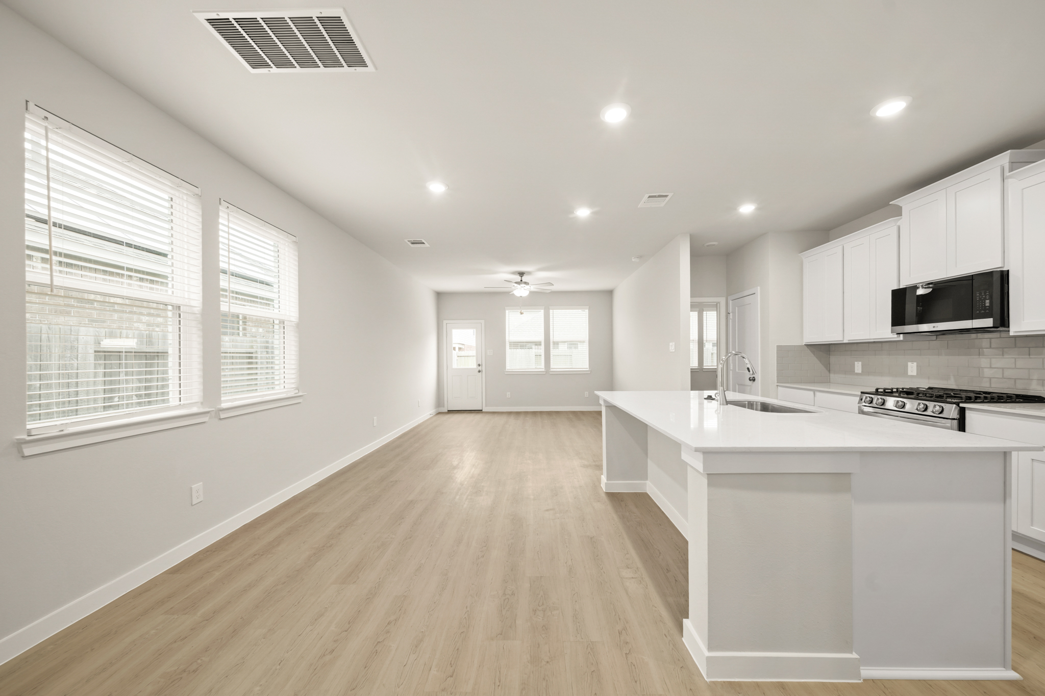 A kitchen with white cabinets.