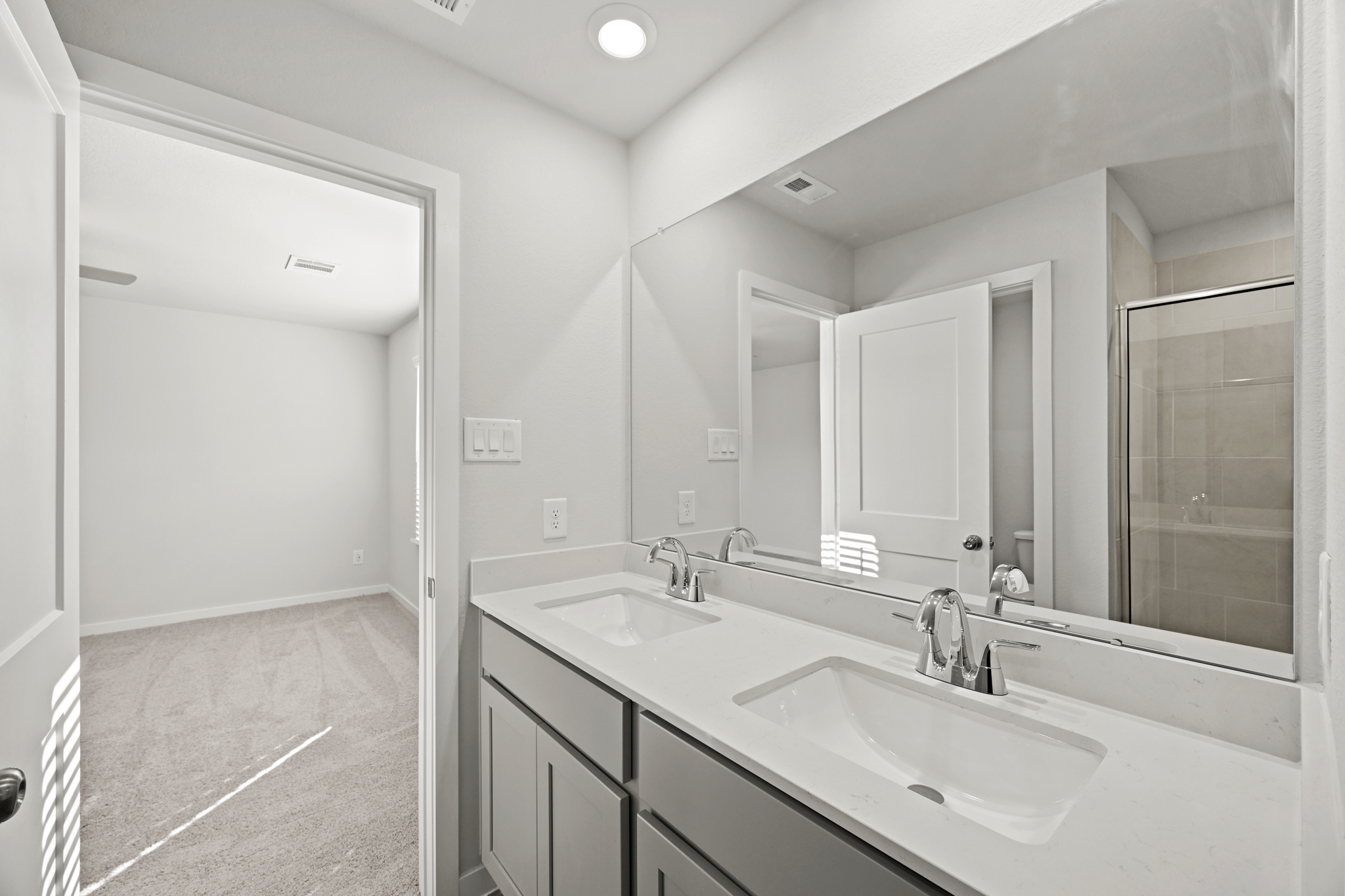 A bathroom with a large mirror.