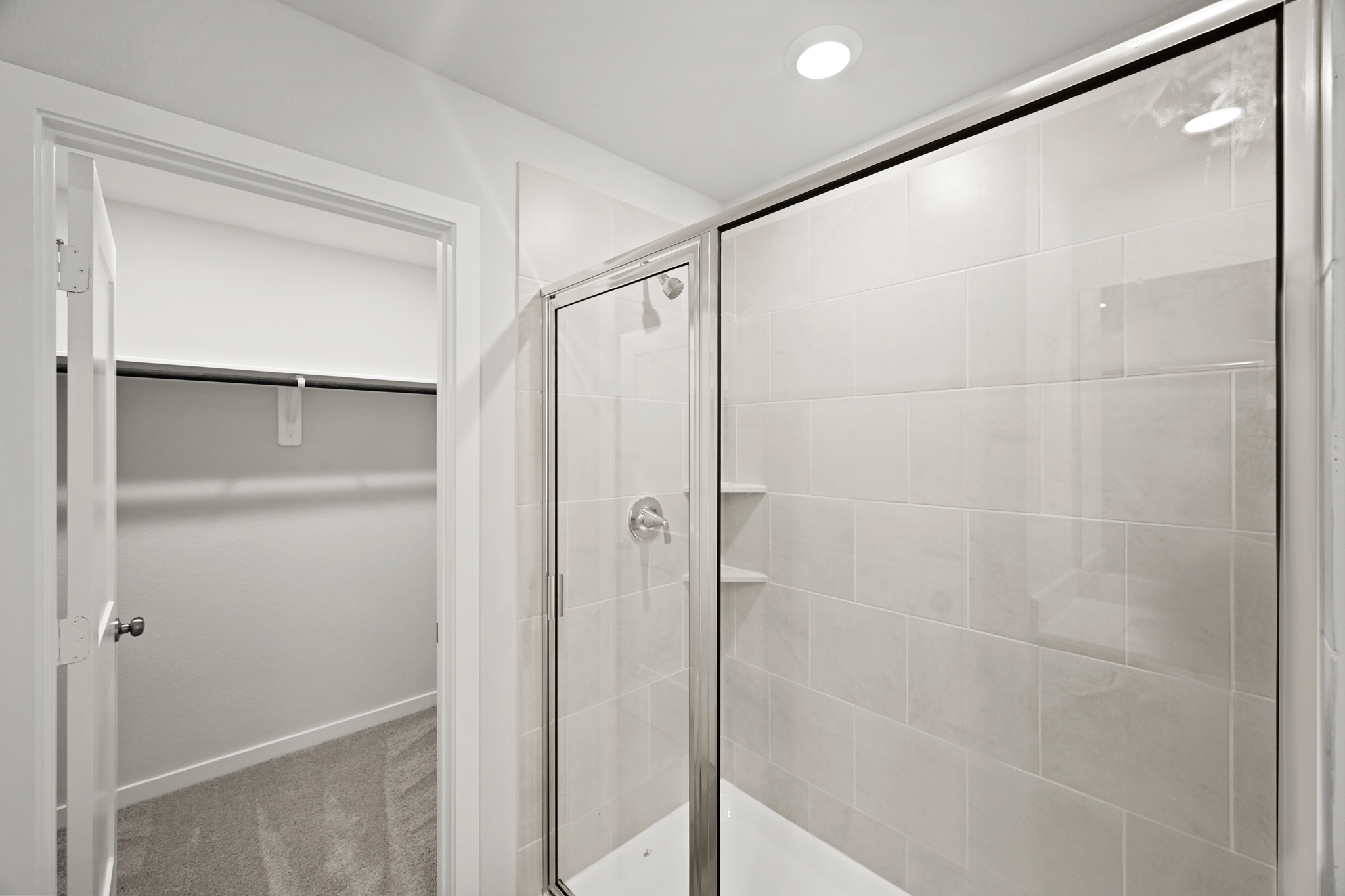 A shower with a glass door.