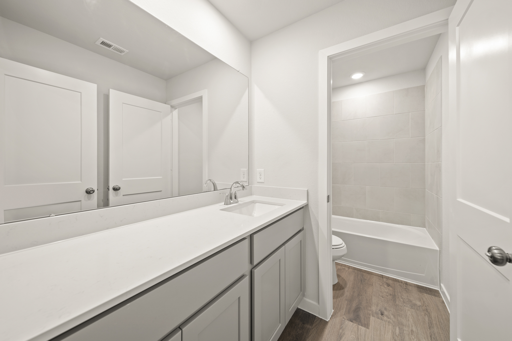 A bathroom with a tub sink and toilet.