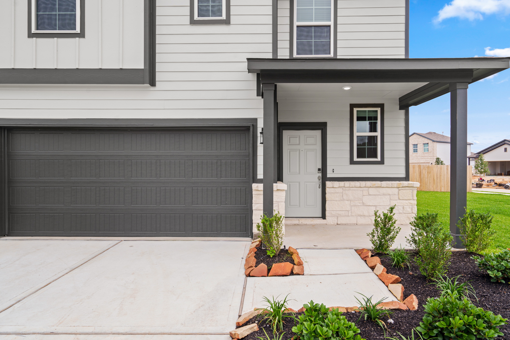 A house with a garage and a small garden.