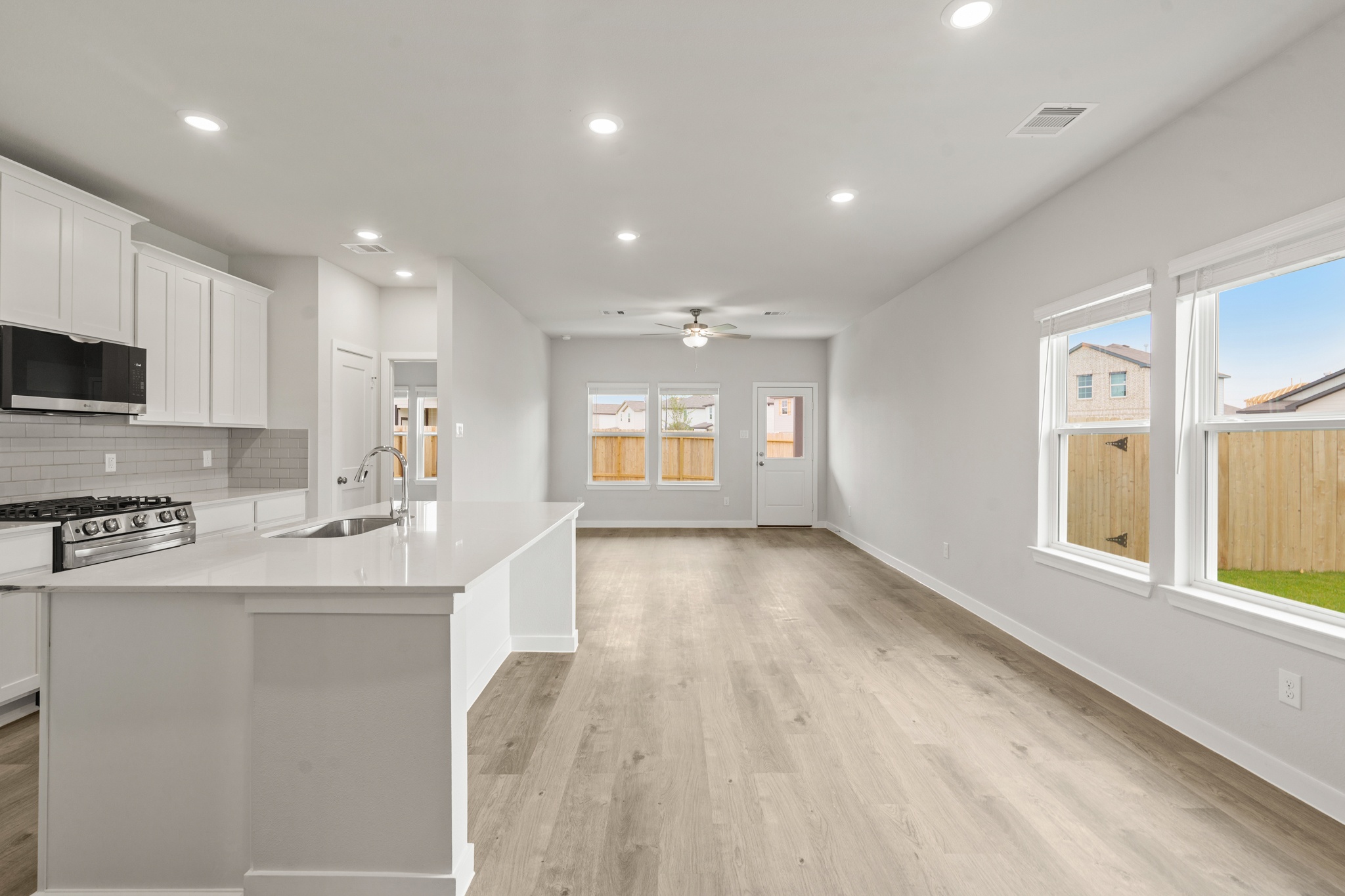 A kitchen with white cabinets.