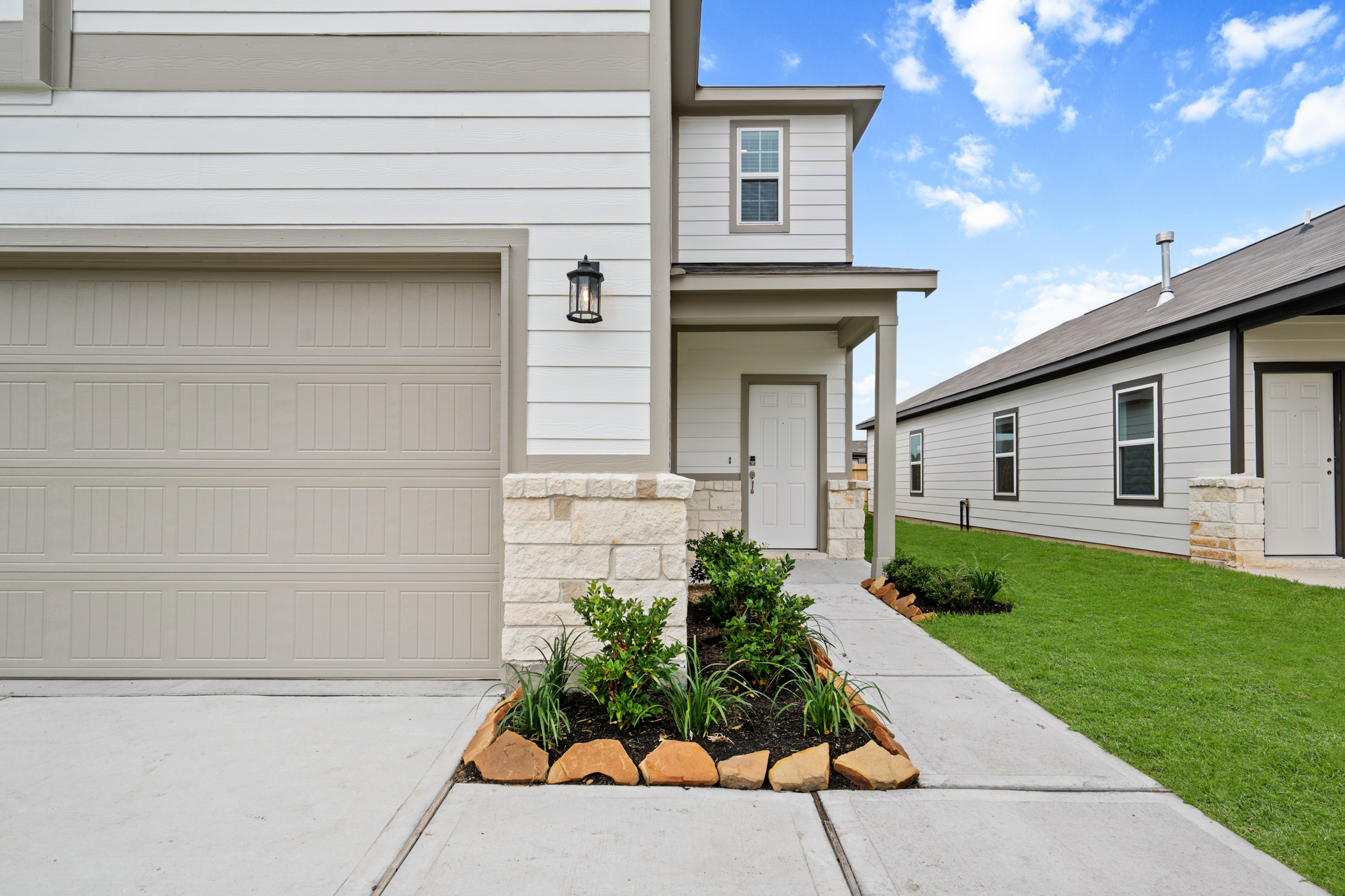 A house with a garage and a lawn.