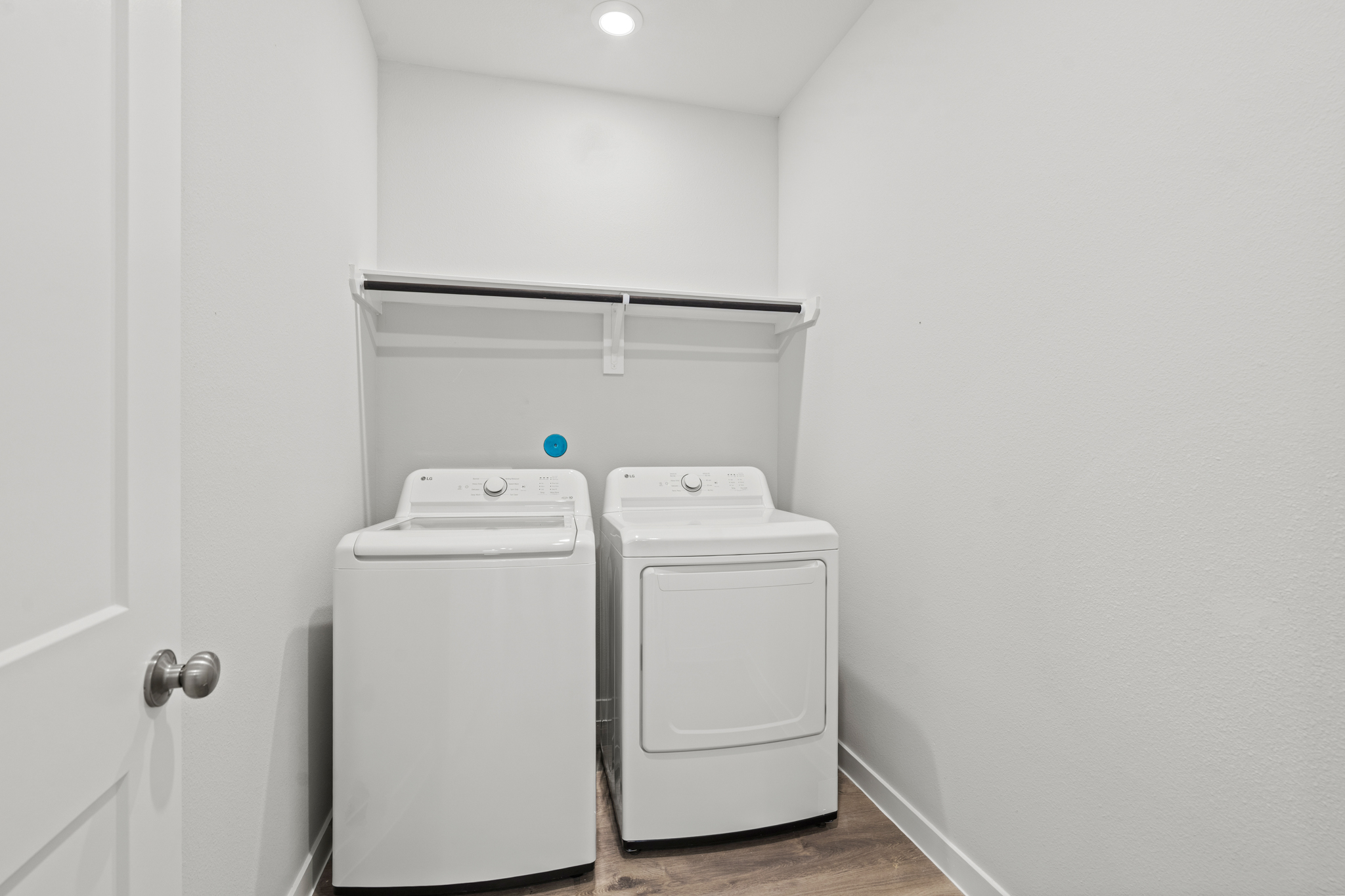 A white wall with a white machine and a white door.